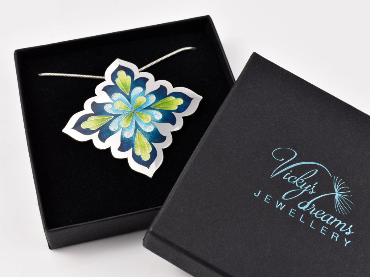 cloisonne pendant with blue and green floral mandala design