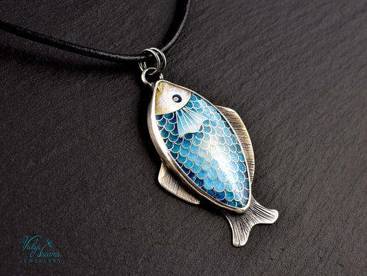 Hand-painted cloisonné enamel blue fish pendant in sterling silver setting.