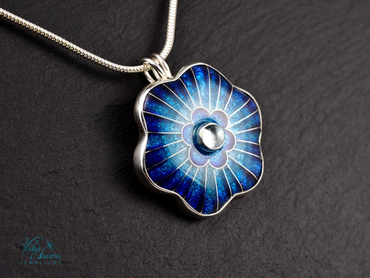 Cloisonné blue flower pendant with natural sky blue topaz set in sterling silver.