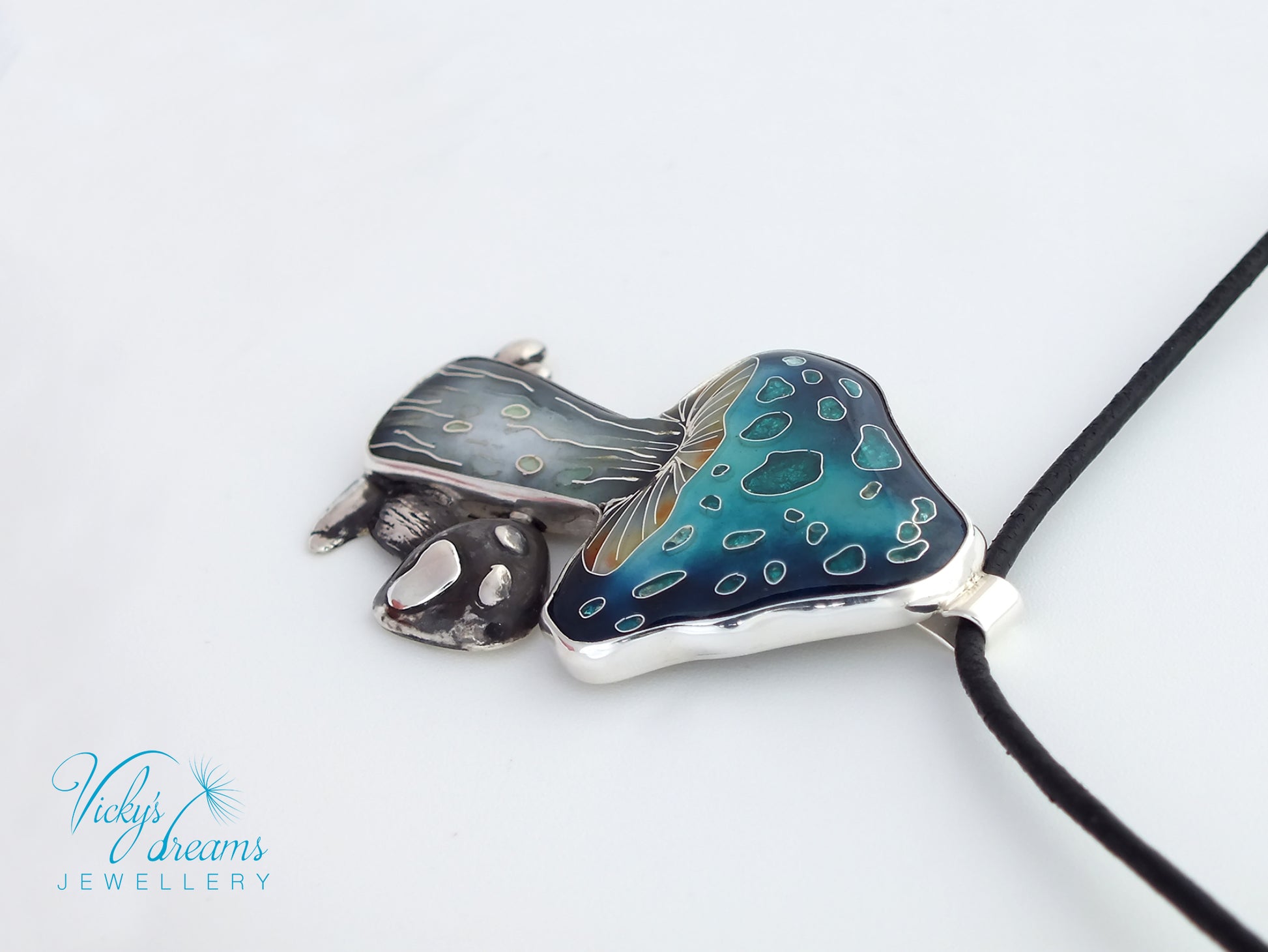 Jewelry pendant with blue and silver design on a white background