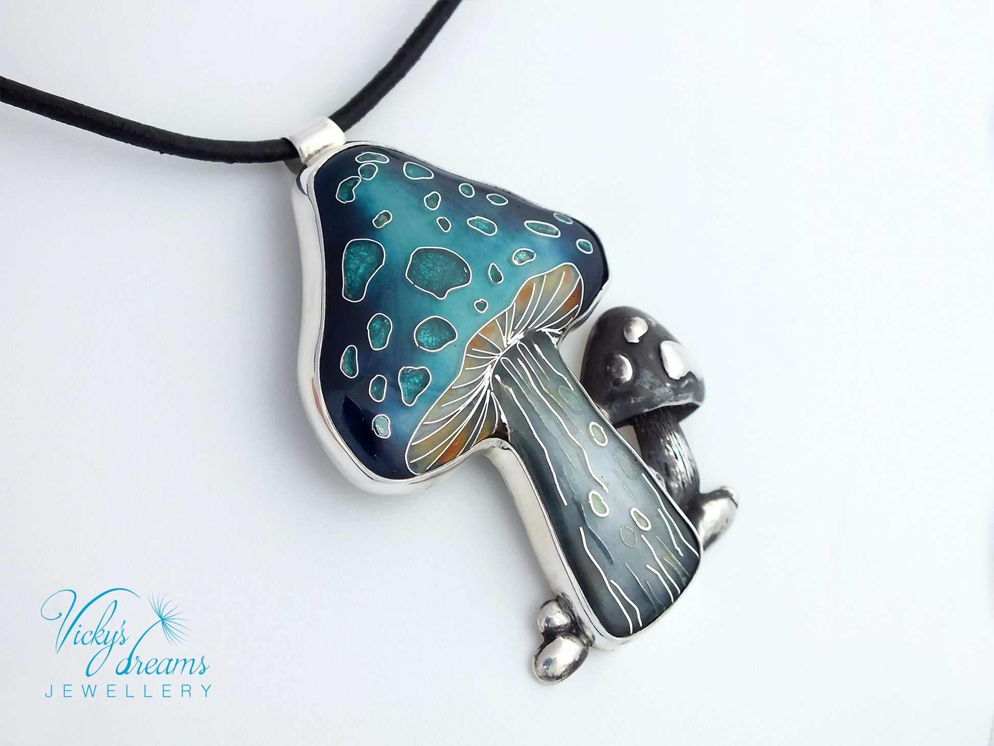 Mushroom-shaped pendant with blue and silver design on a white background