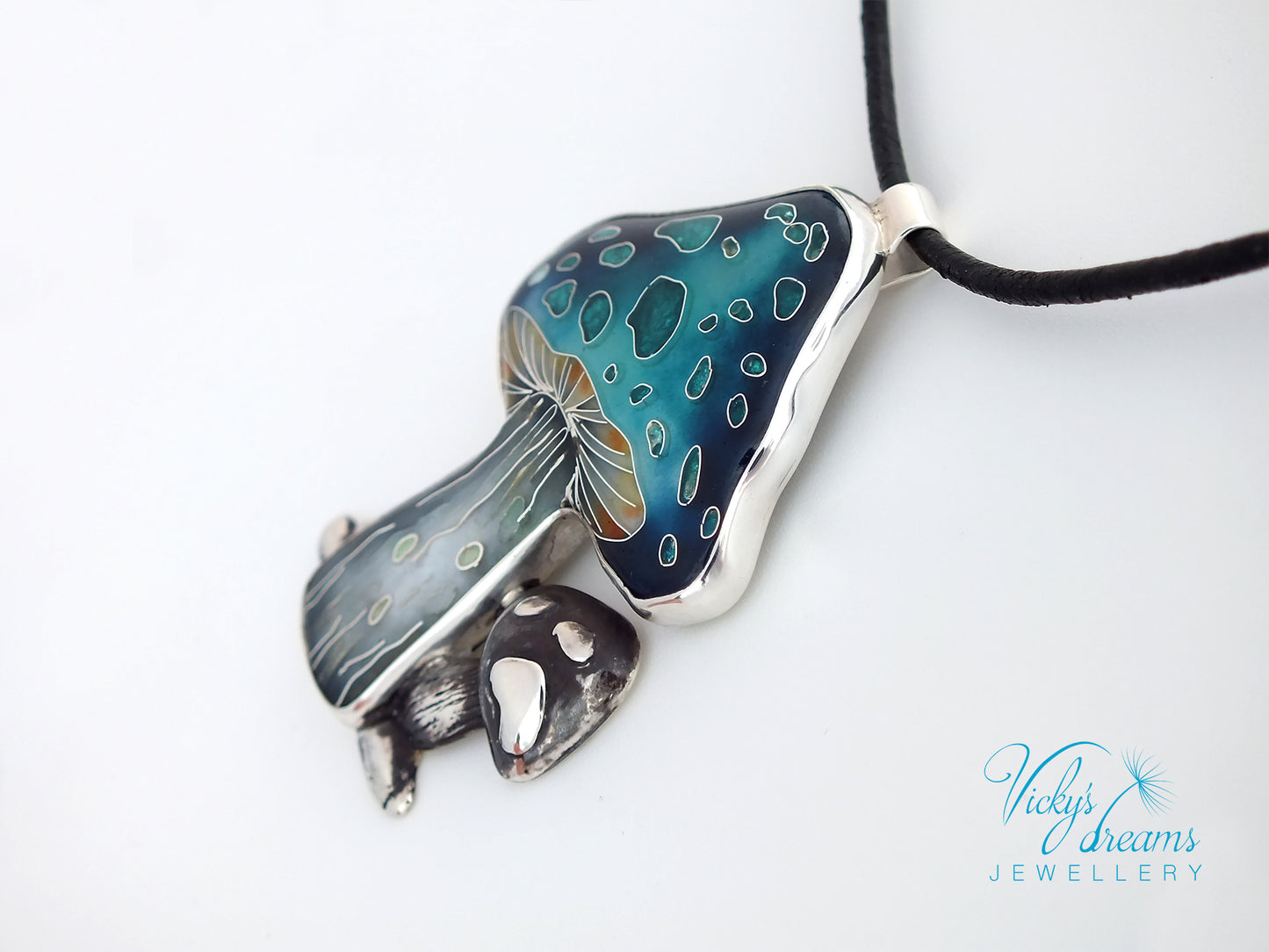 Jewelry pendant with blue and silver design on a white background