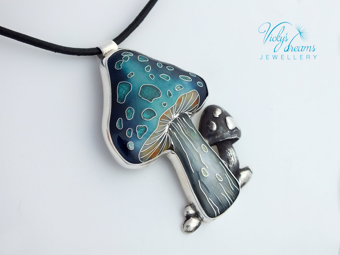 Mushroom-shaped pendant with blue and silver design on a white background