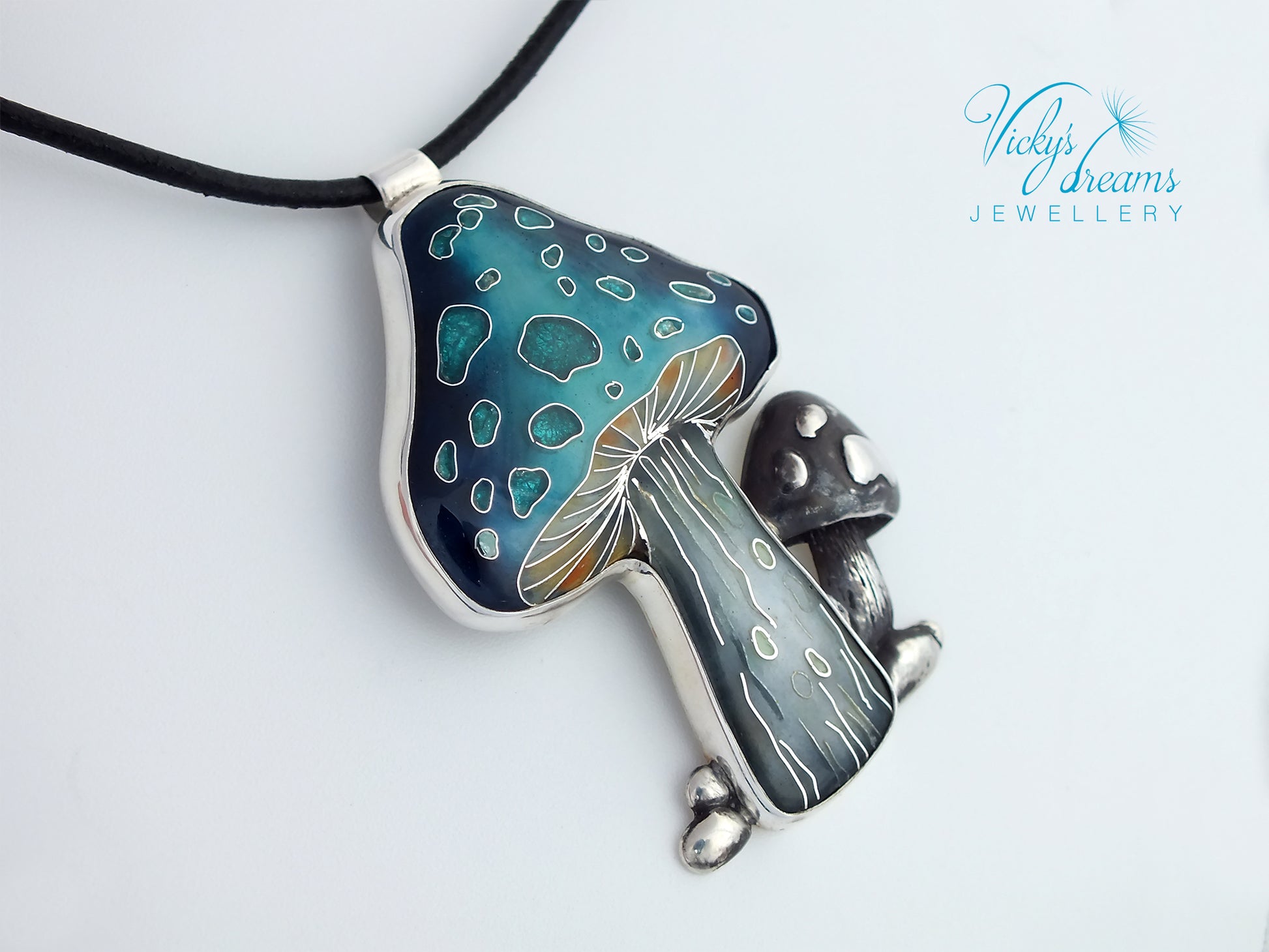 Mushroom-shaped pendant with blue and silver design on a white background