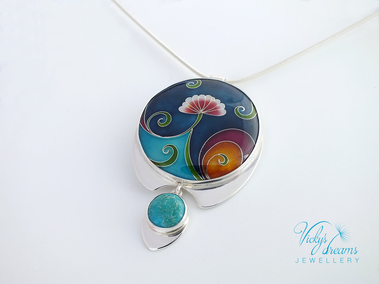 Colorful pendant with floral design on a white background, featuring the brand 'Vicky's Dreams Jewellery'.