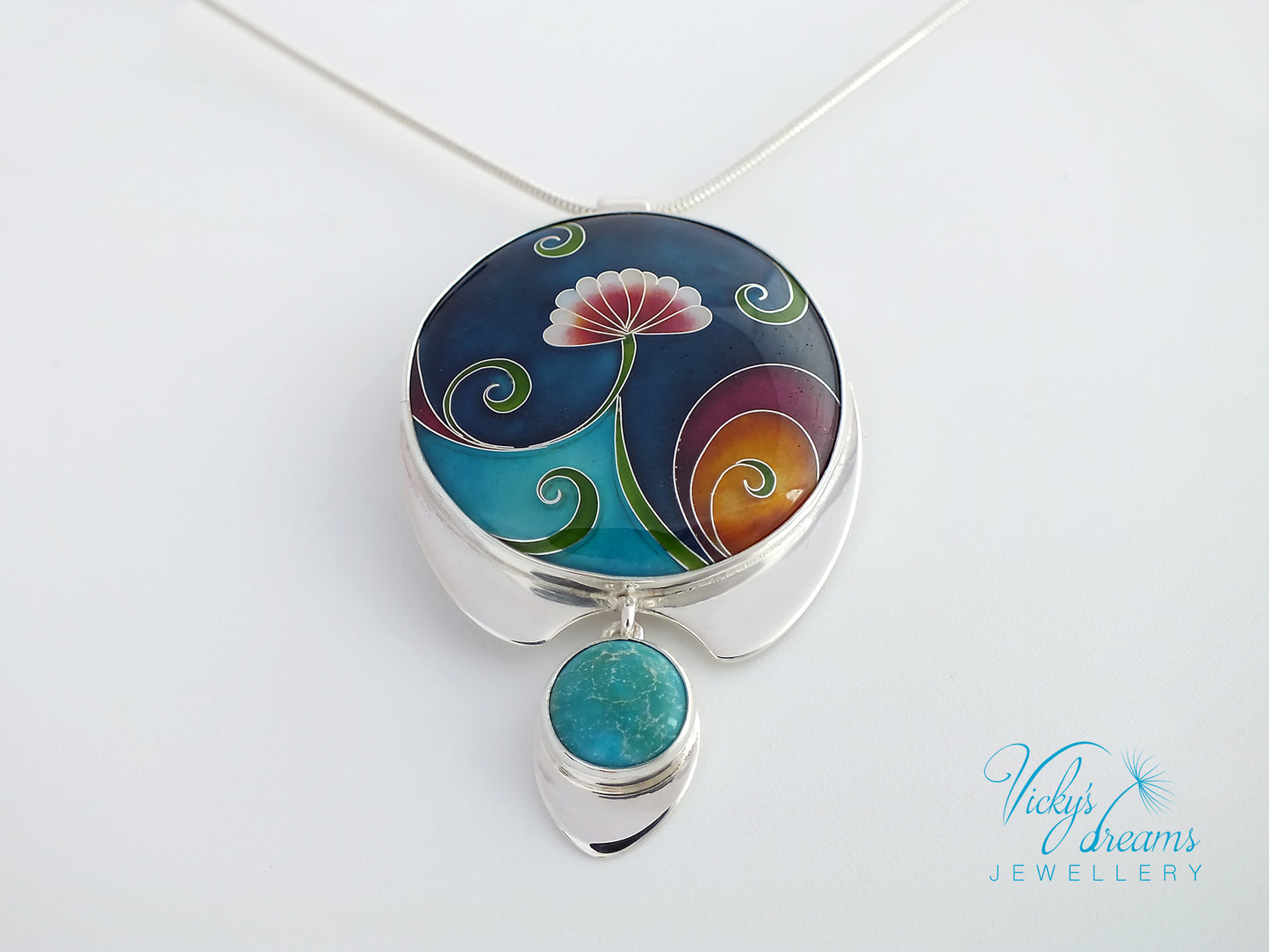 Colorful pendant with floral design on a white background, branded 'Vicky's Dreams Jewellery'.