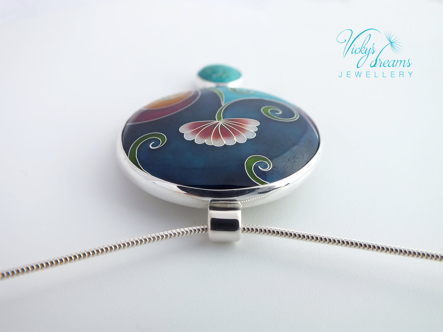 Jewelry pendant with floral design on a white background, branded 'Vicky Davies Jewellery'.
