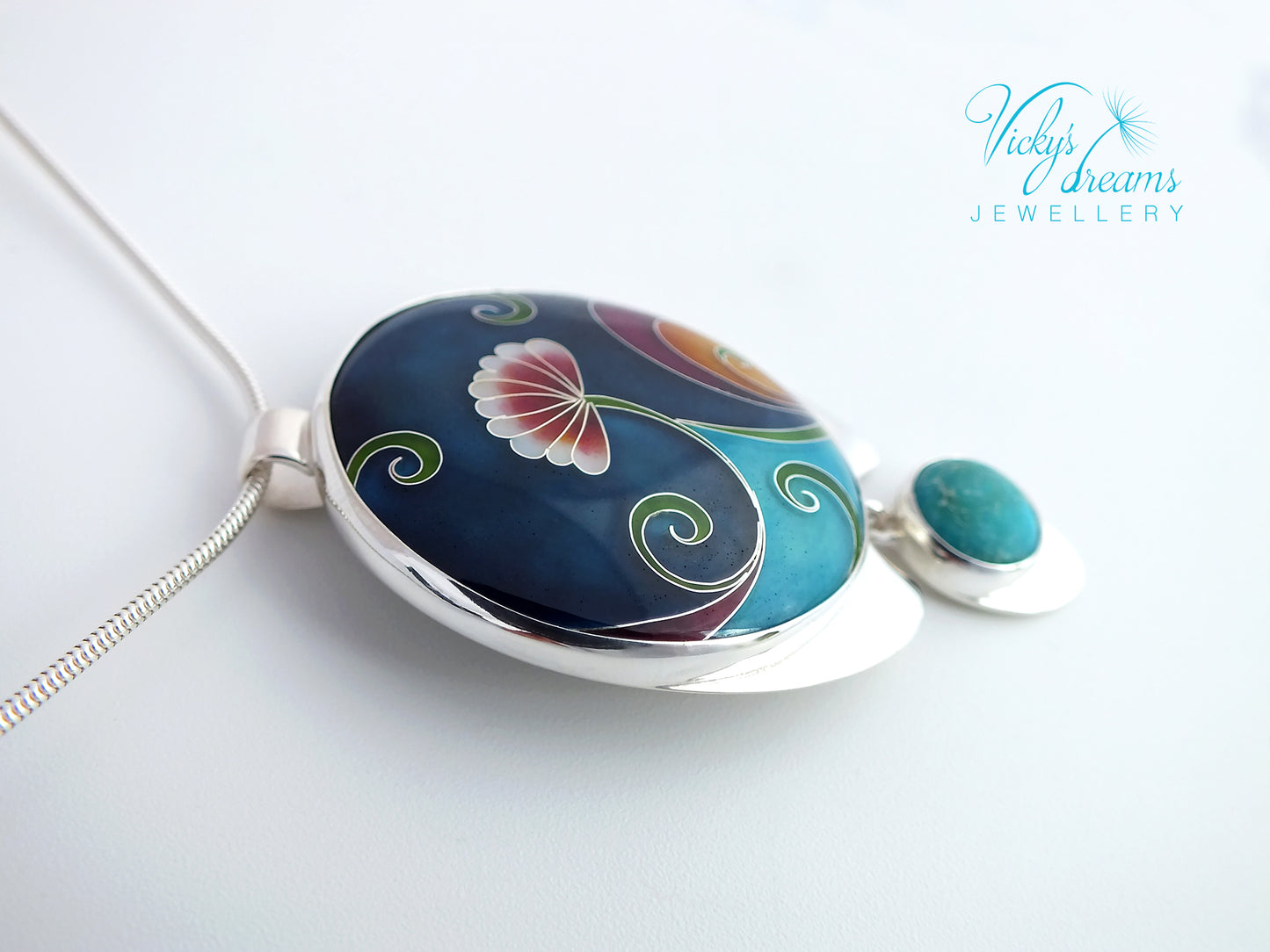 Jewelry with a colorful pendant and turquoise stone on a white background