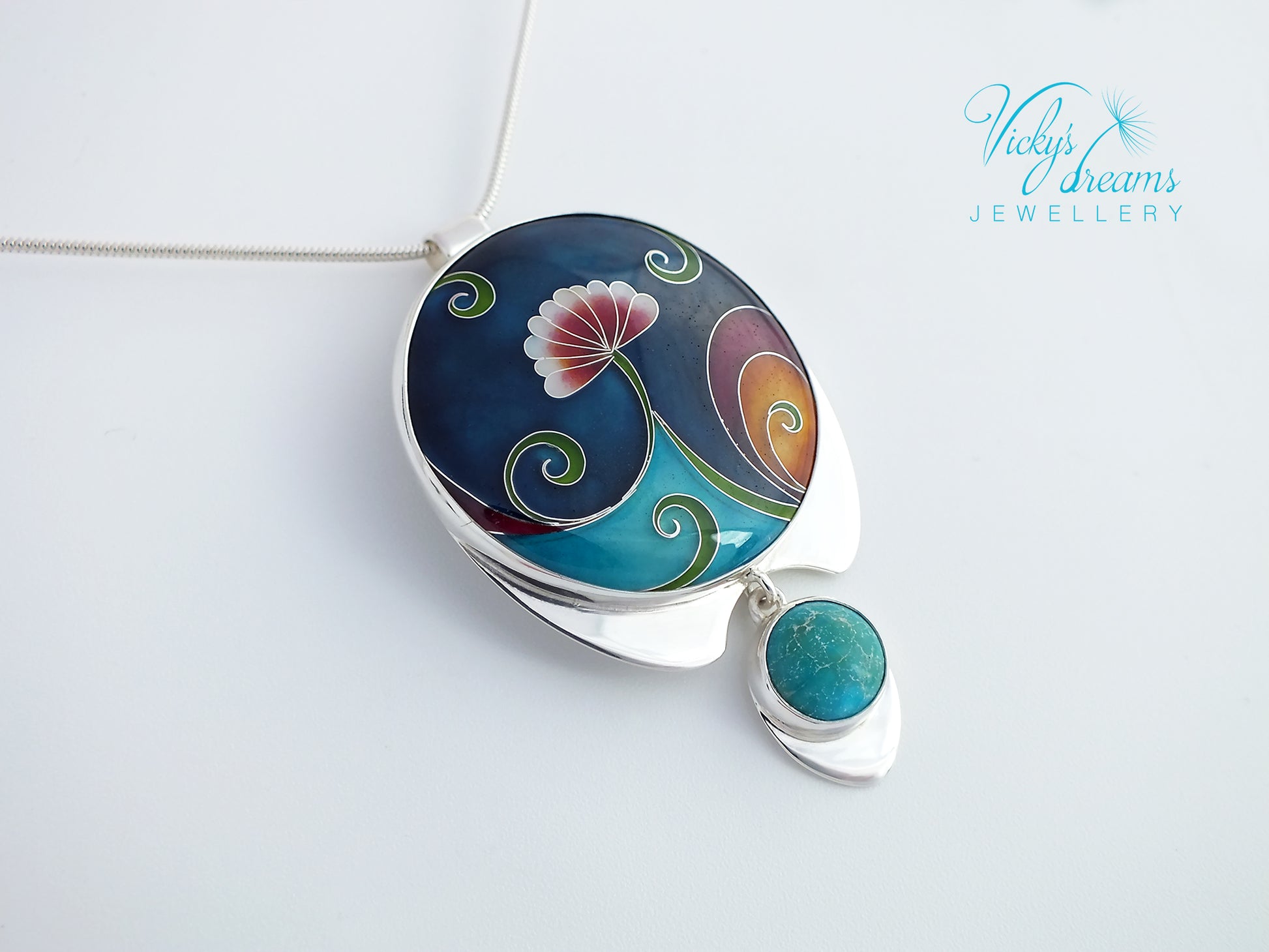 Jewelry pendant with floral design on a white background, featuring the brand 'Vicky Trevis'.