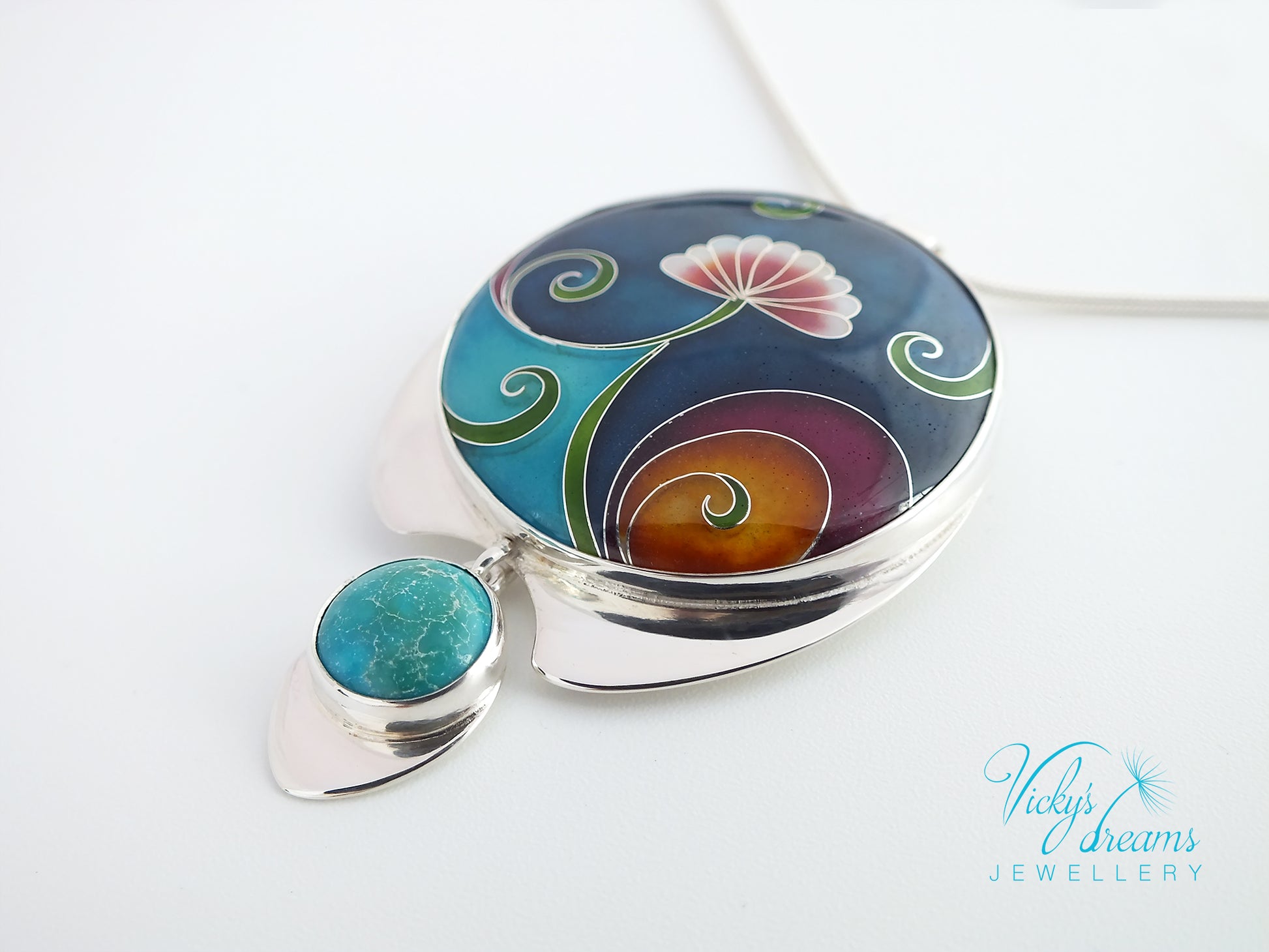 Jewelry box with floral design and turquoise stone on a white background