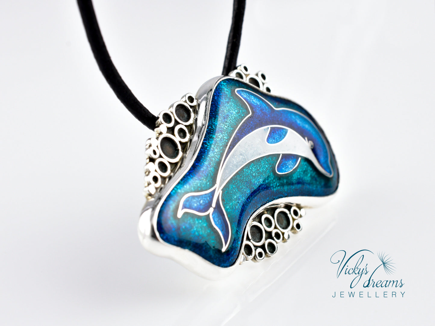 Dolphin pendant necklace with blue and silver design on a white background