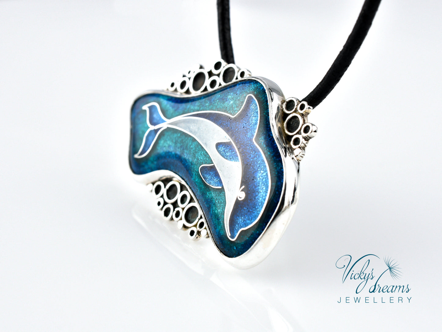 Dolphin-shaped pendant on a black cord with 'Vicky's Dreams Jewellery' branding.