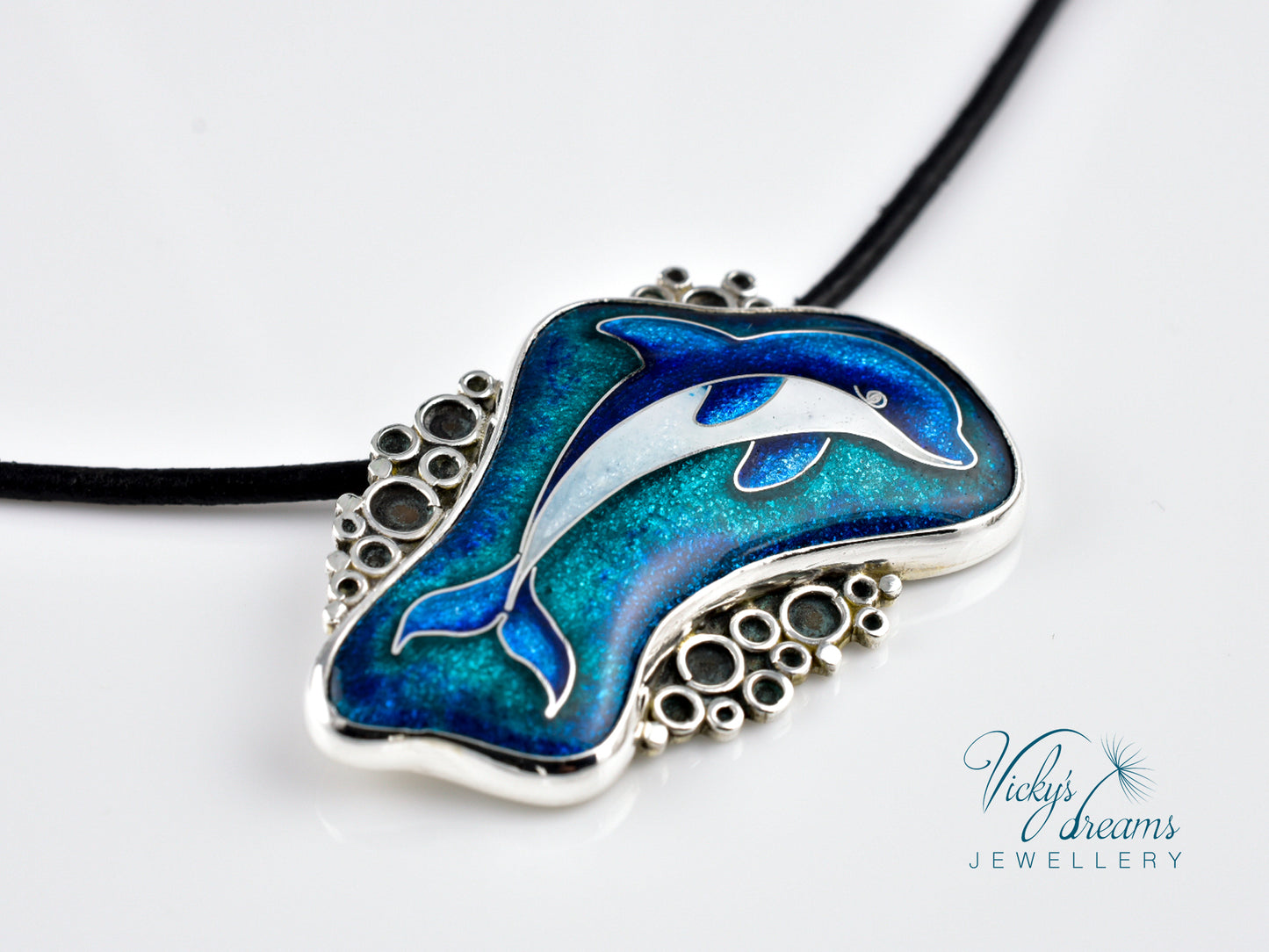 Dolphin pendant necklace with blue and silver design on a white background