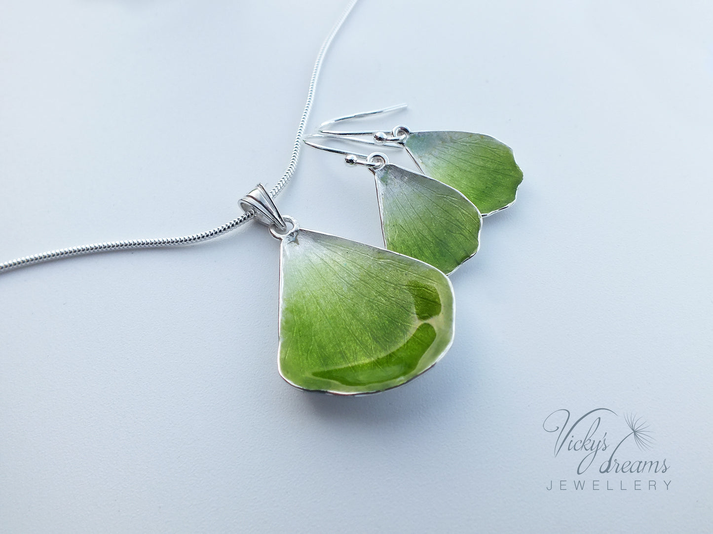 Green flower petal pendant worn on sterling silver necklace