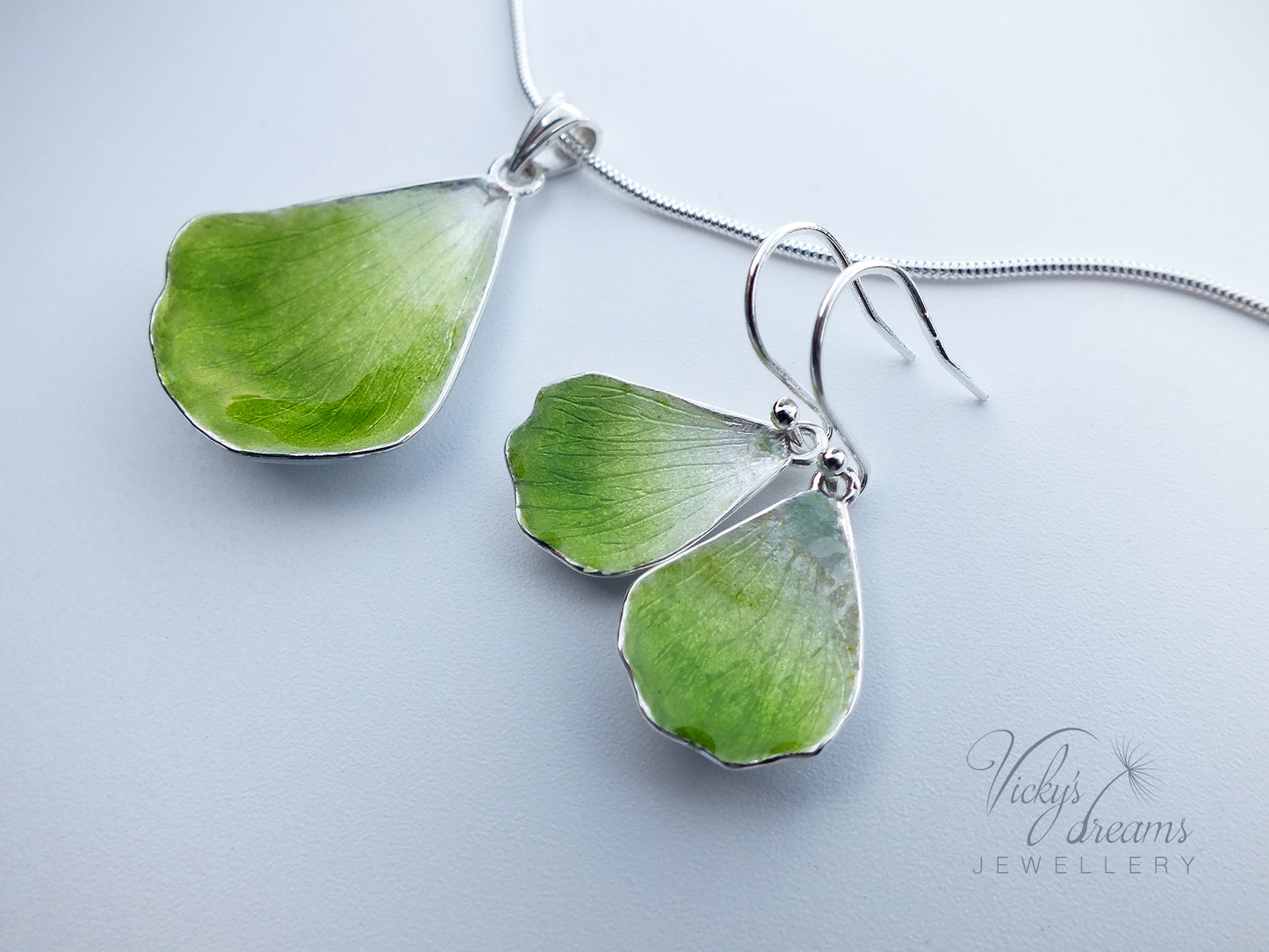 Green flower petal pendant worn on sterling silver necklace