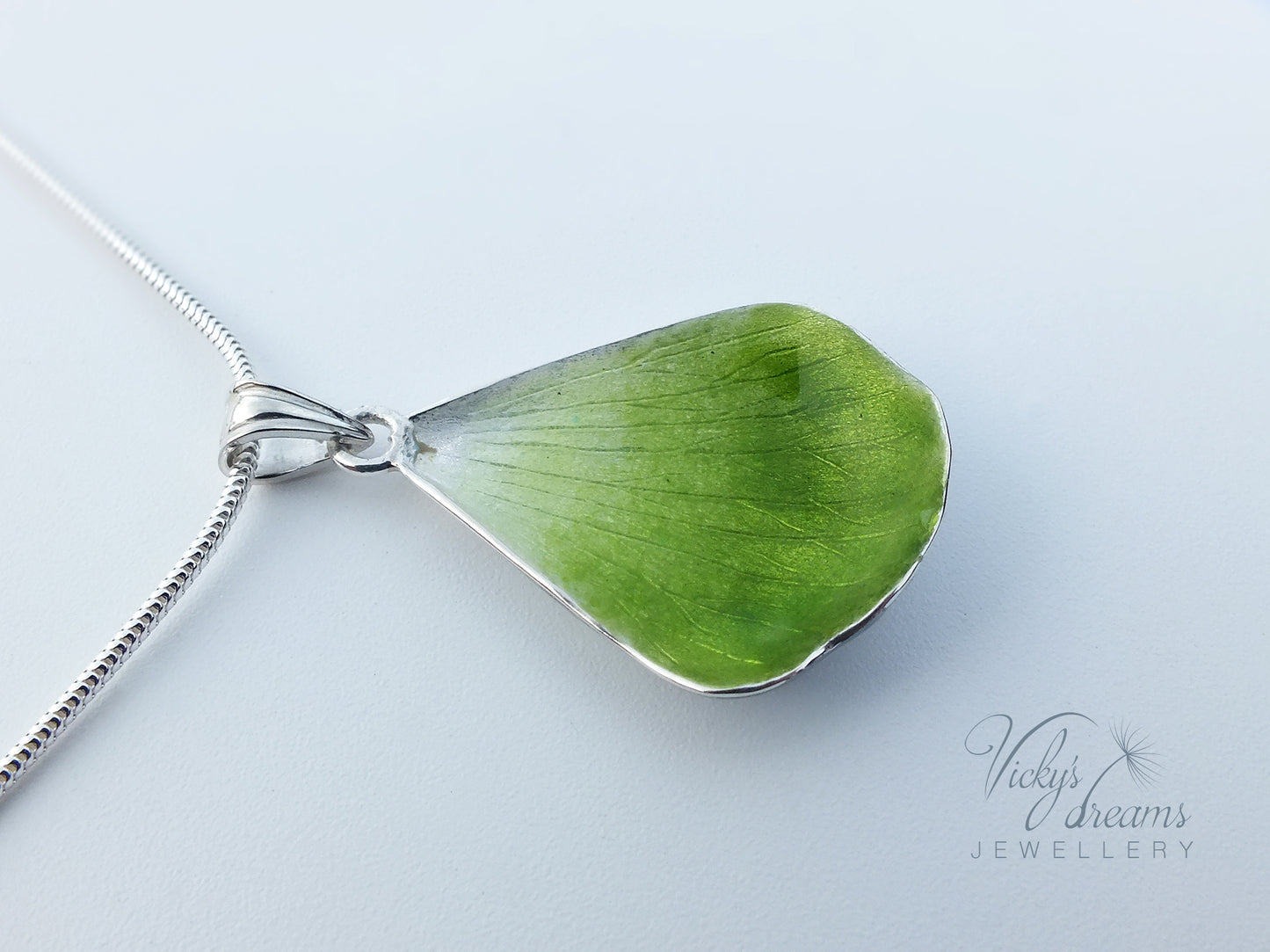 Green flower petal pendant worn on sterling silver necklace