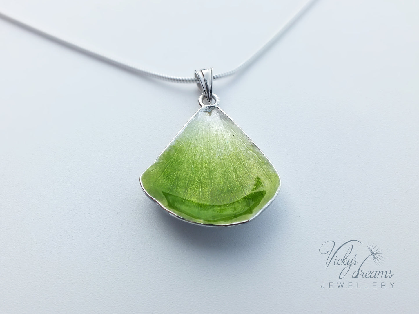 Green flower petal pendant worn on sterling silver necklace
