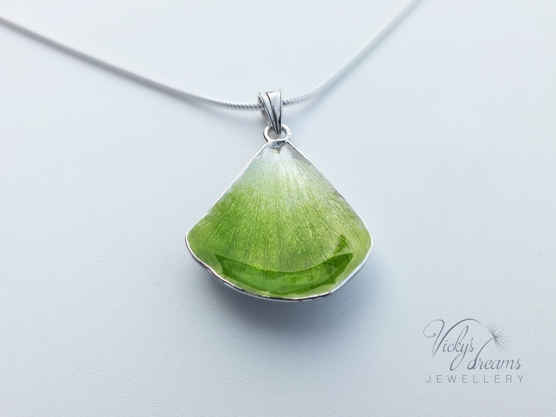 Green flower petal pendant worn on sterling silver necklace
