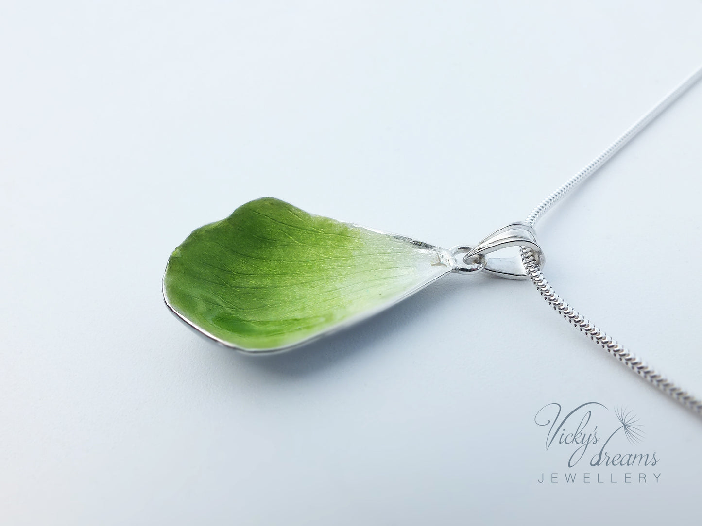 Green flower petal pendant worn on sterling silver necklace