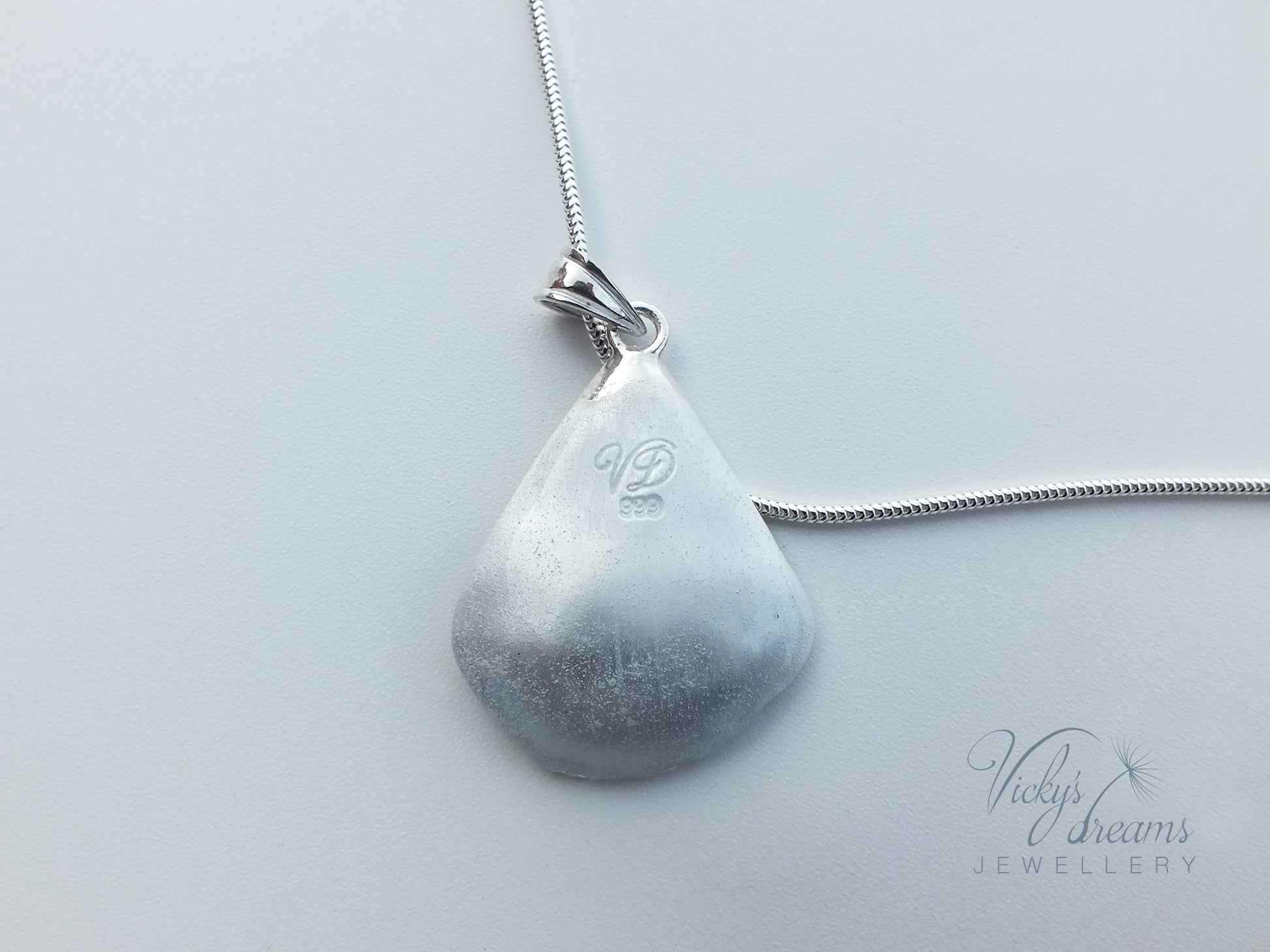 Green flower petal pendant worn on sterling silver necklace