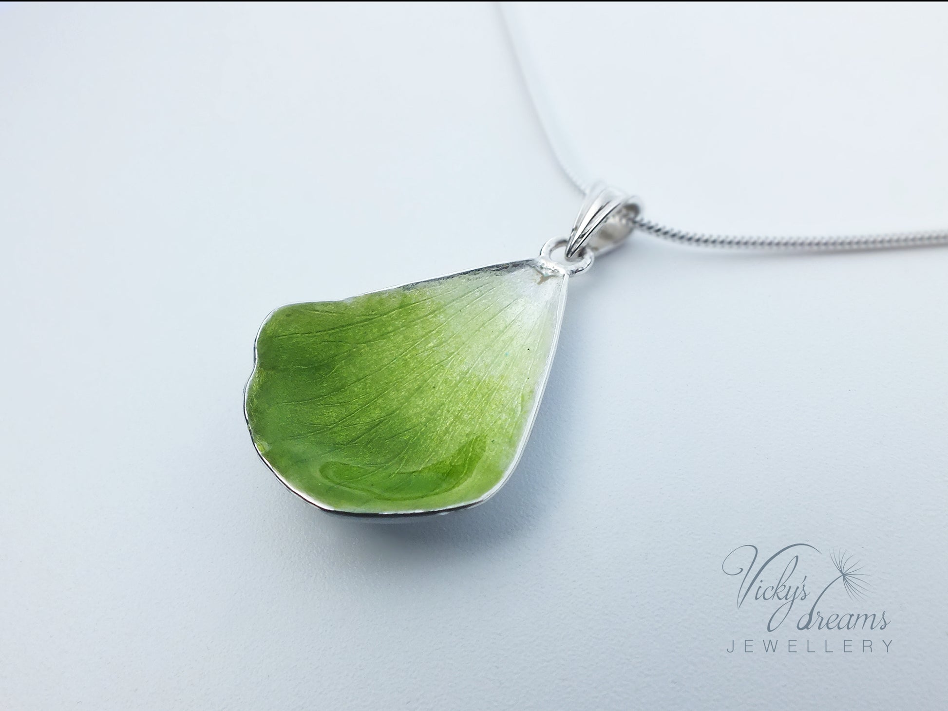 Green flower petal pendant worn on sterling silver necklace