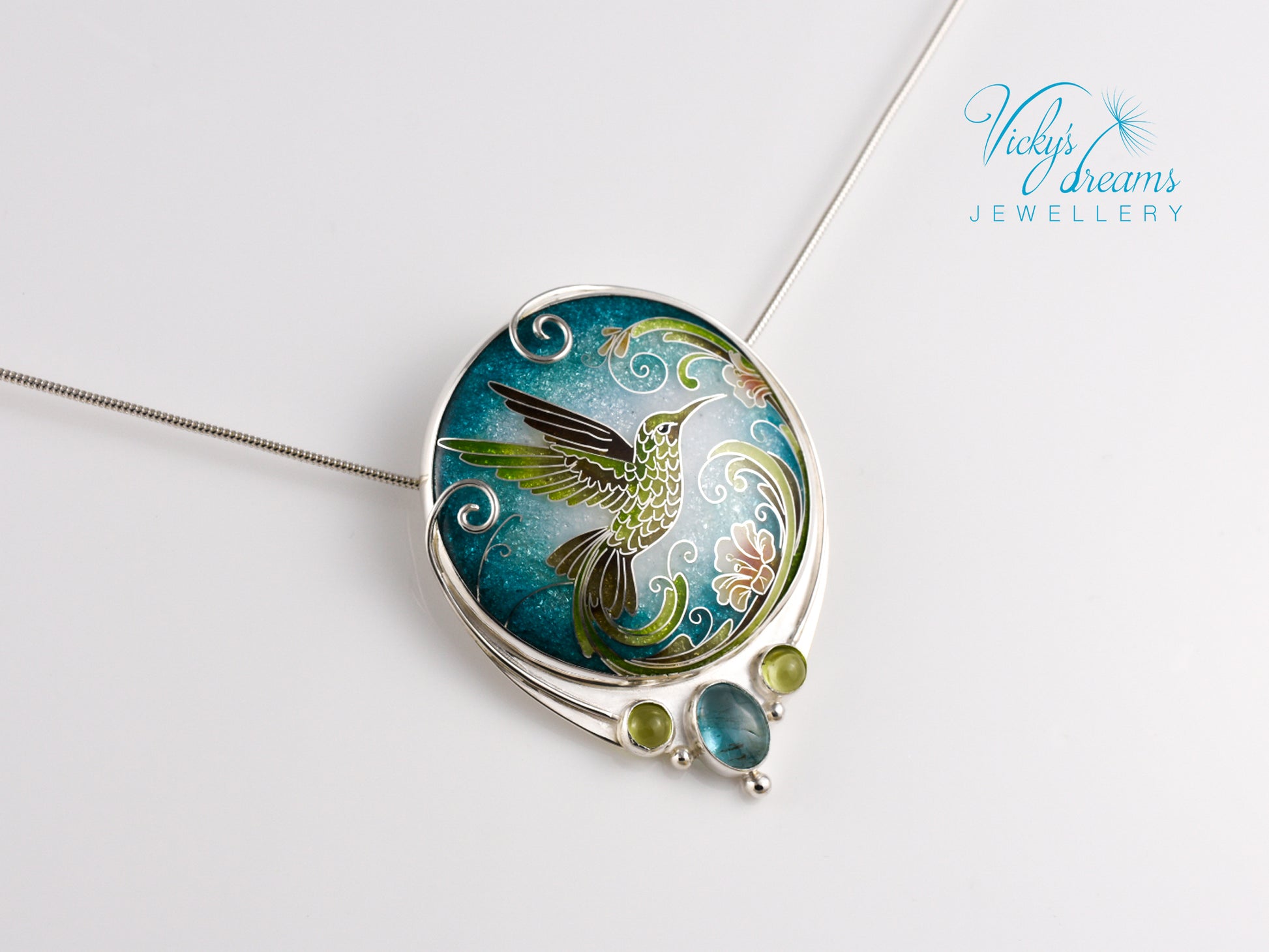 Handcrafted hummingbird pendant with cloisonné enamel and gemstone accents