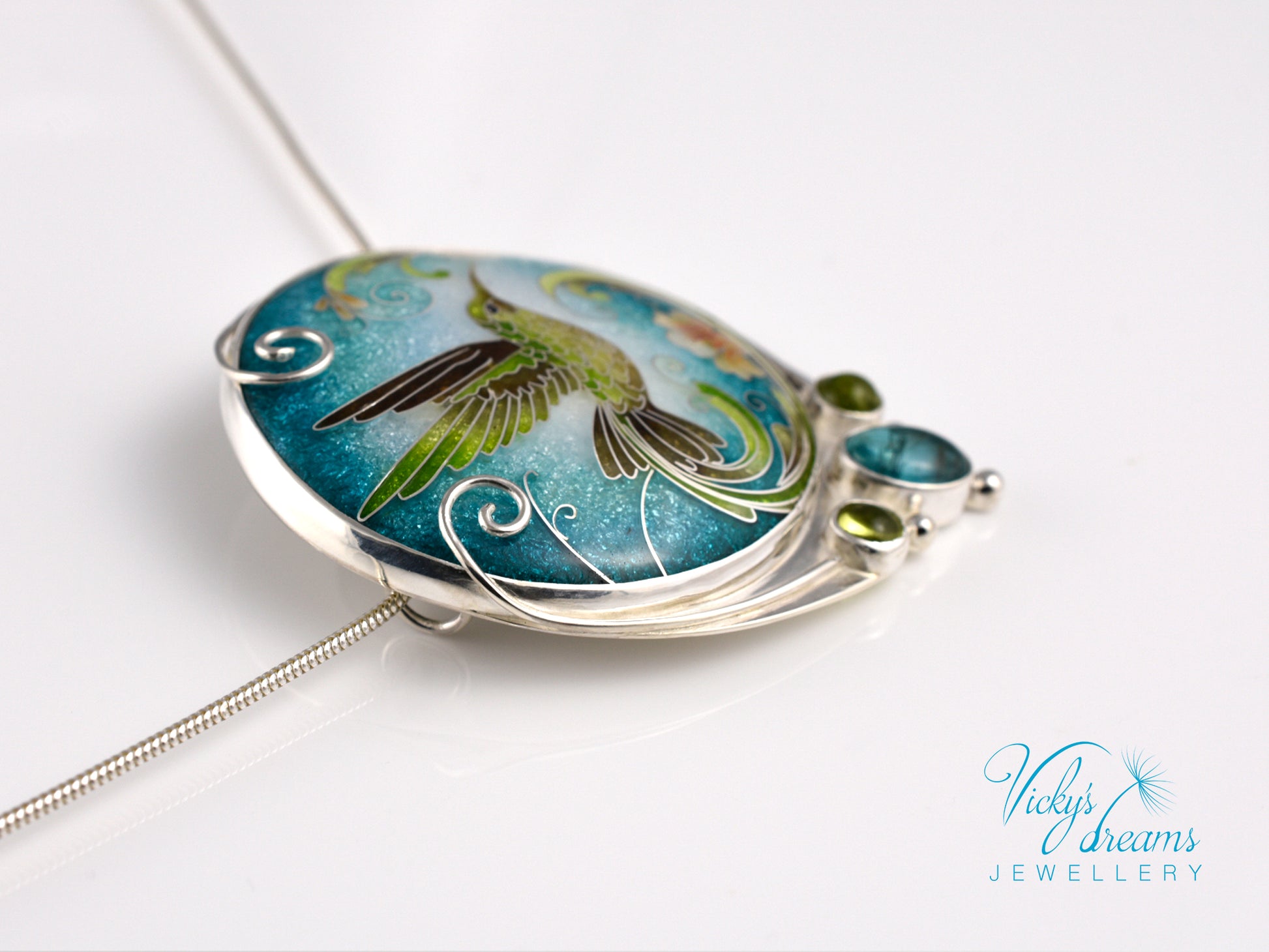 Handcrafted hummingbird pendant with cloisonné enamel and gemstone accents