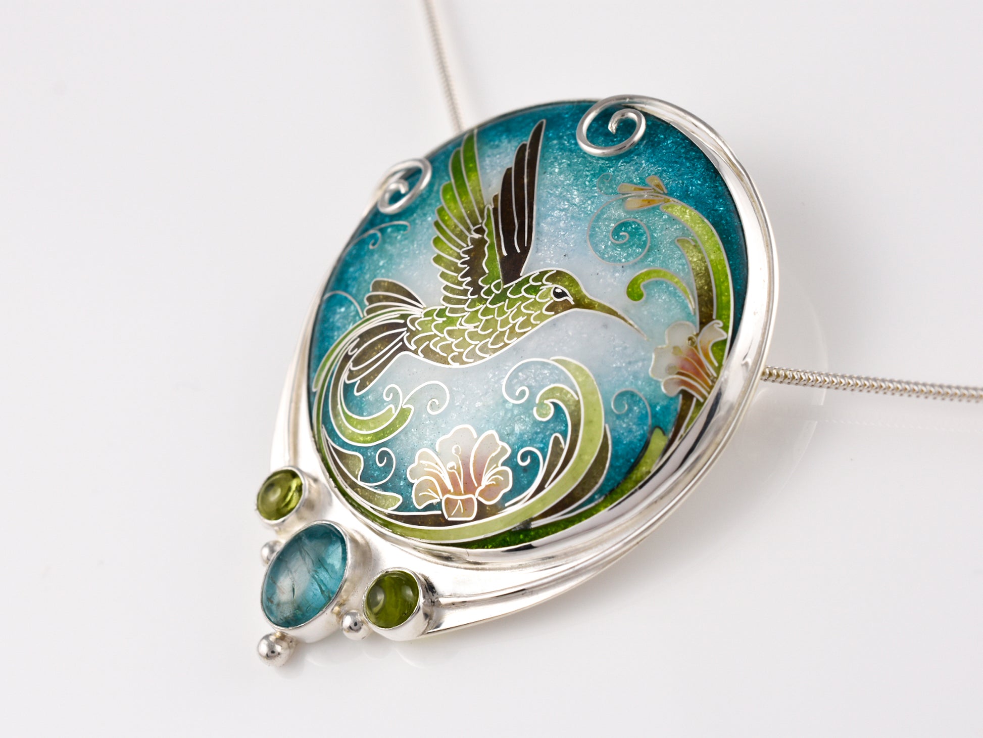 Handcrafted hummingbird pendant with cloisonné enamel and gemstone accents