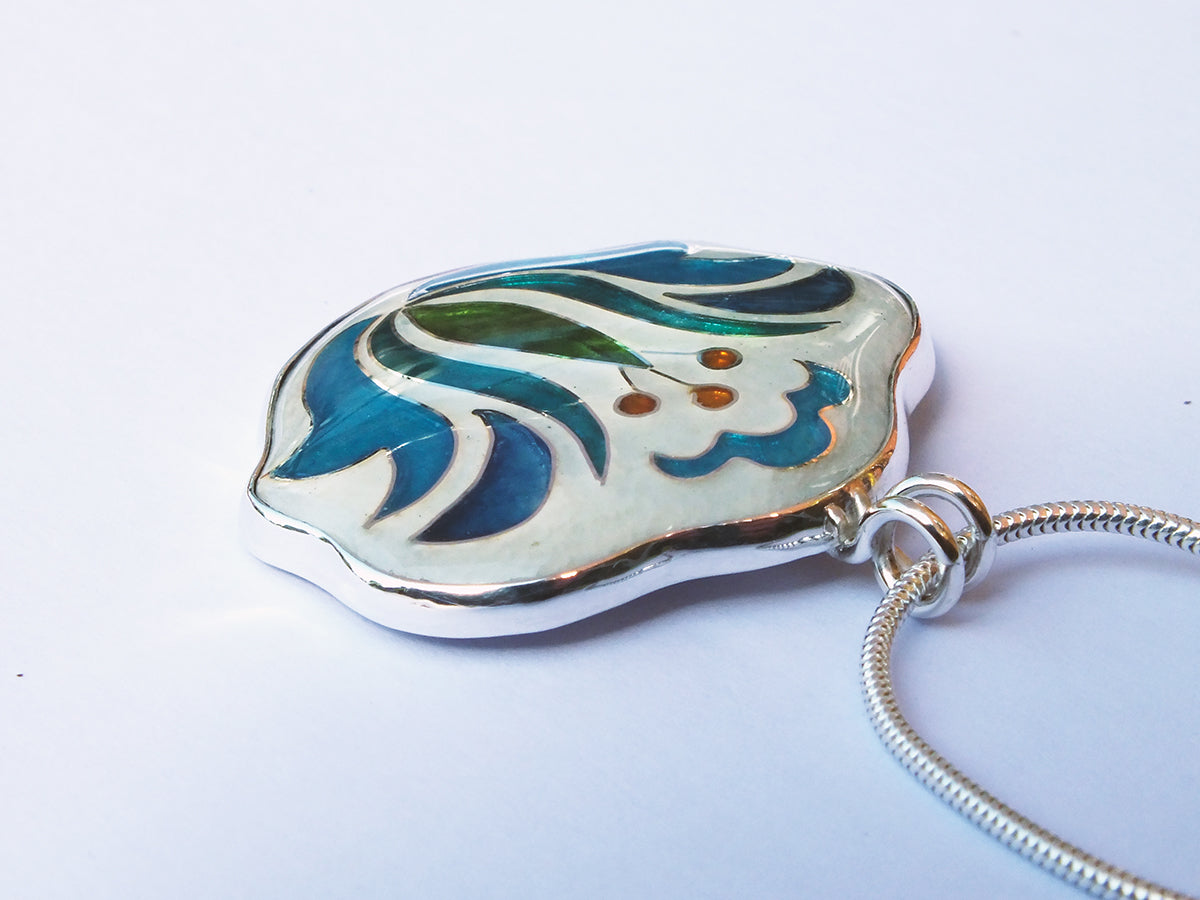 Decorative pendant with floral design on a white background