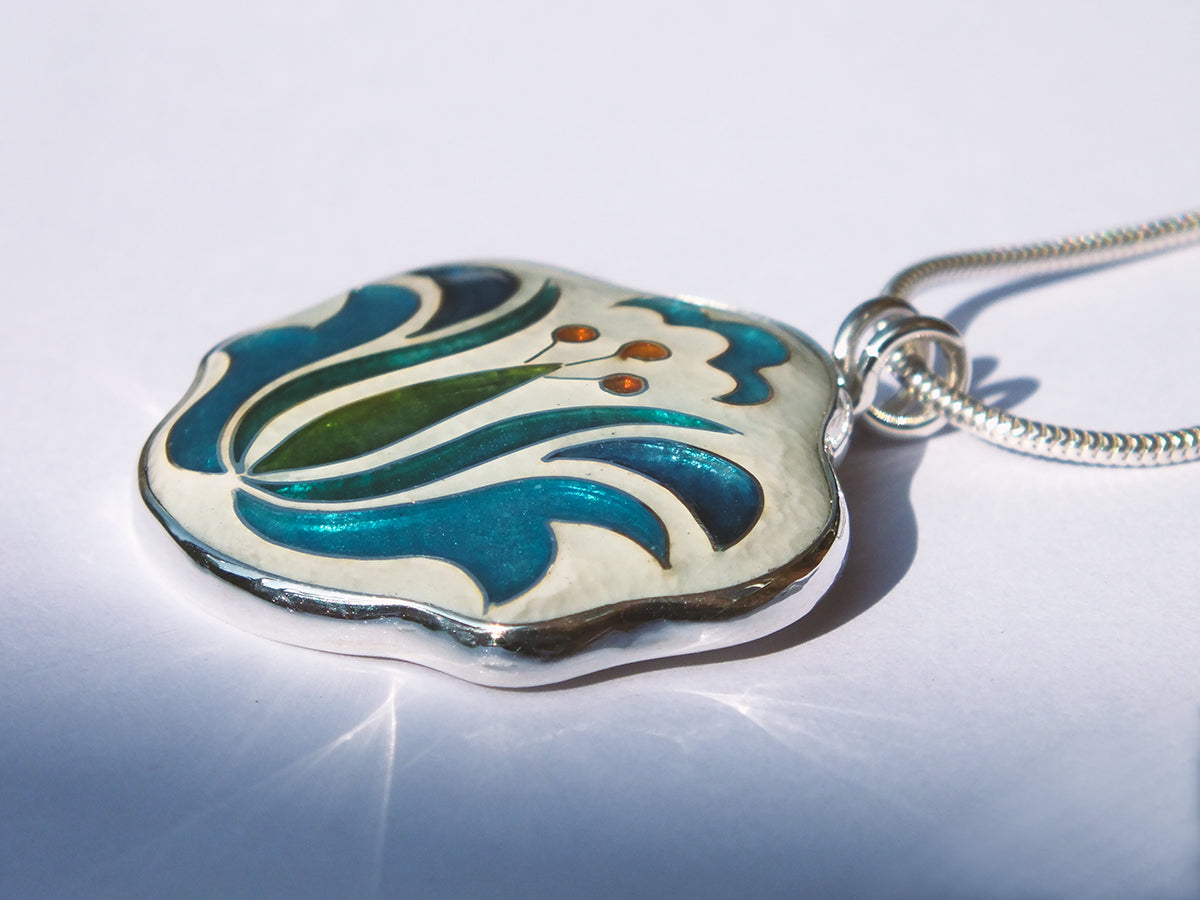 Decorative pendant with floral design on a white background