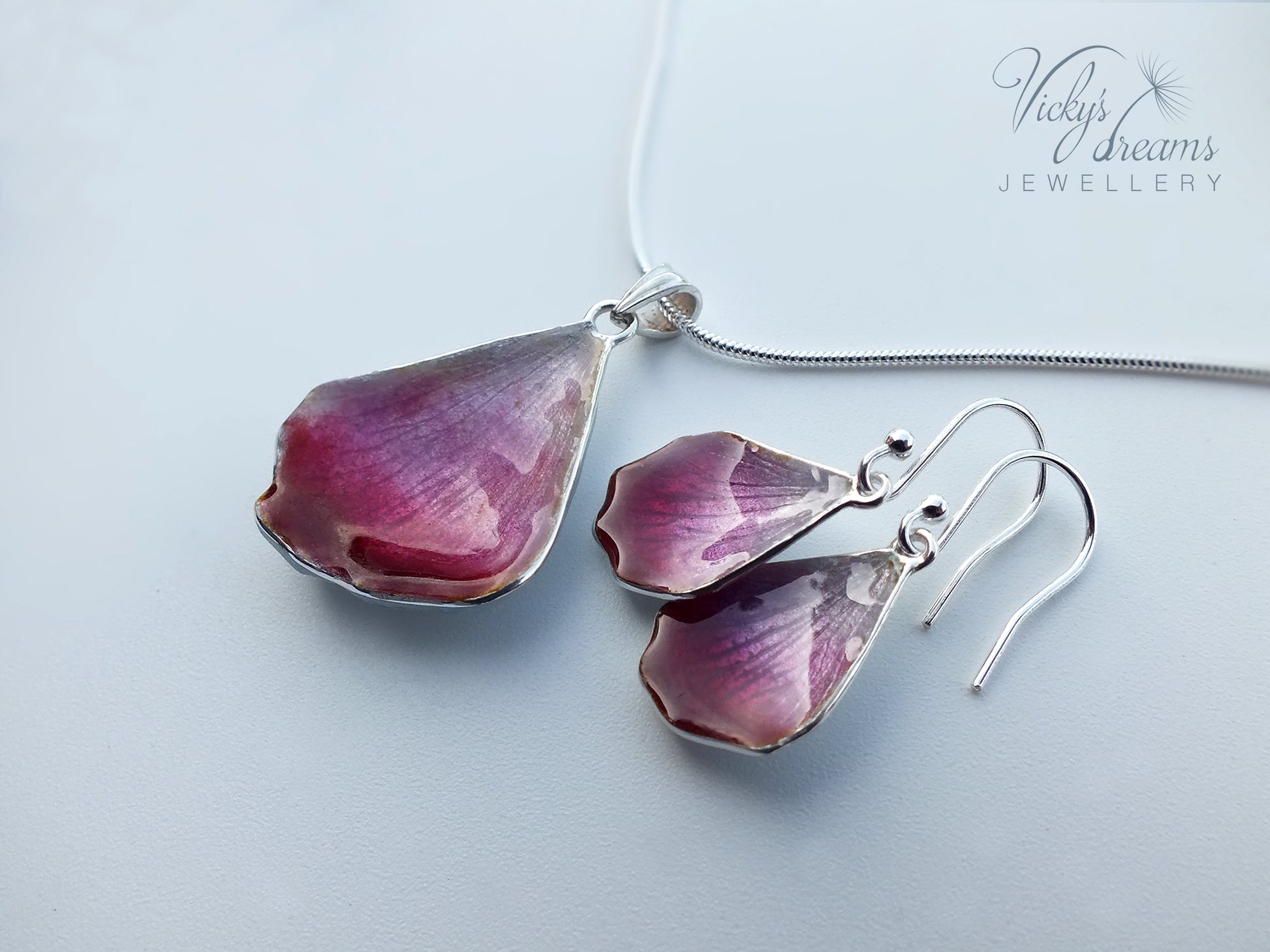Pink flower petal pendant worn on sterling silver necklace