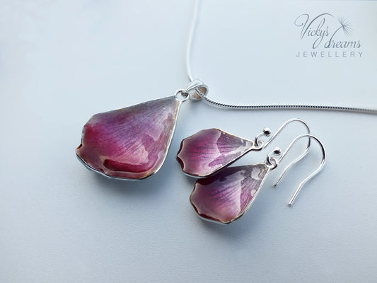 Pink flower petal pendant worn on sterling silver necklace