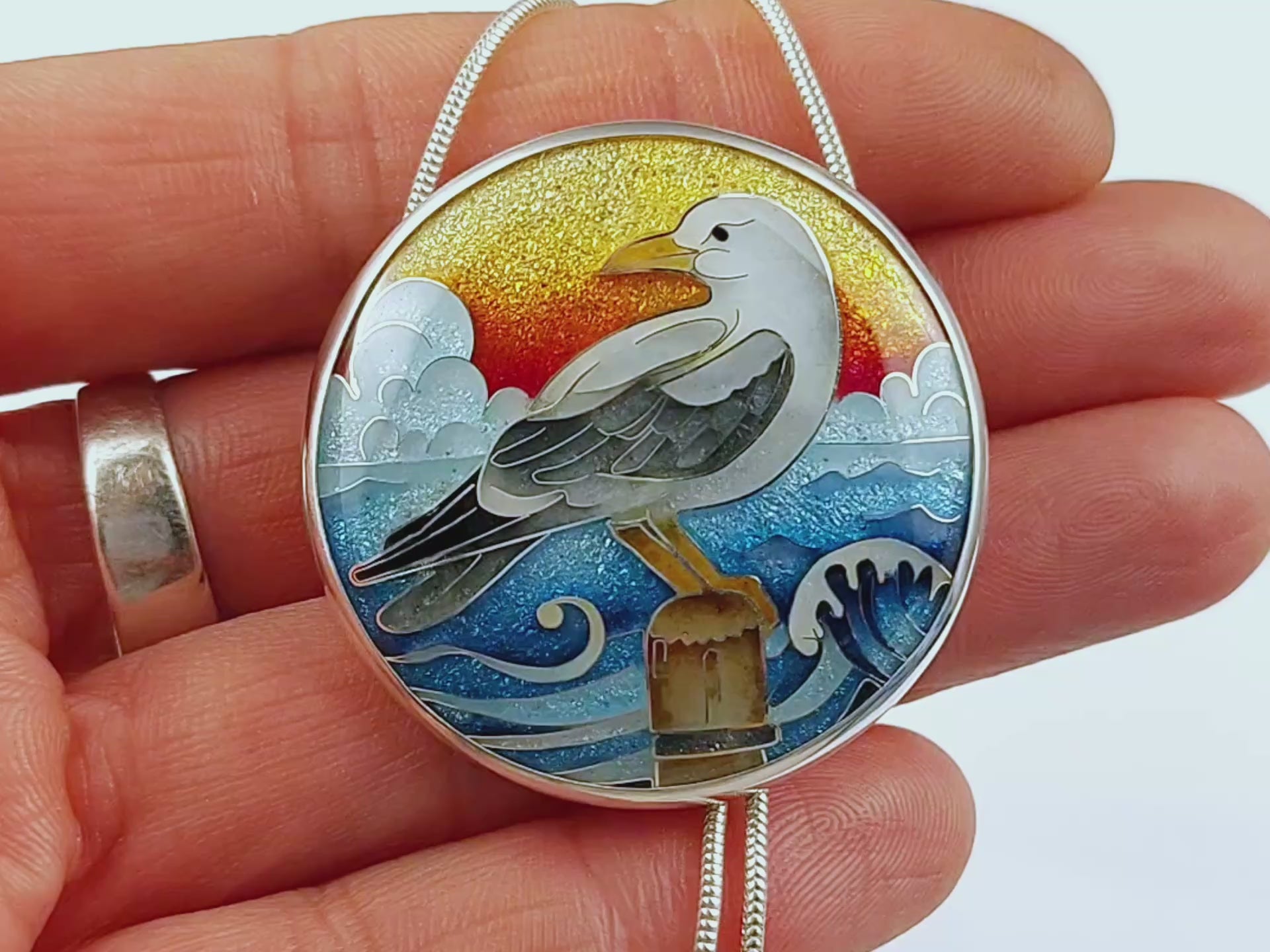 Handmade cloisonné seagull pendant necklace with sunset background