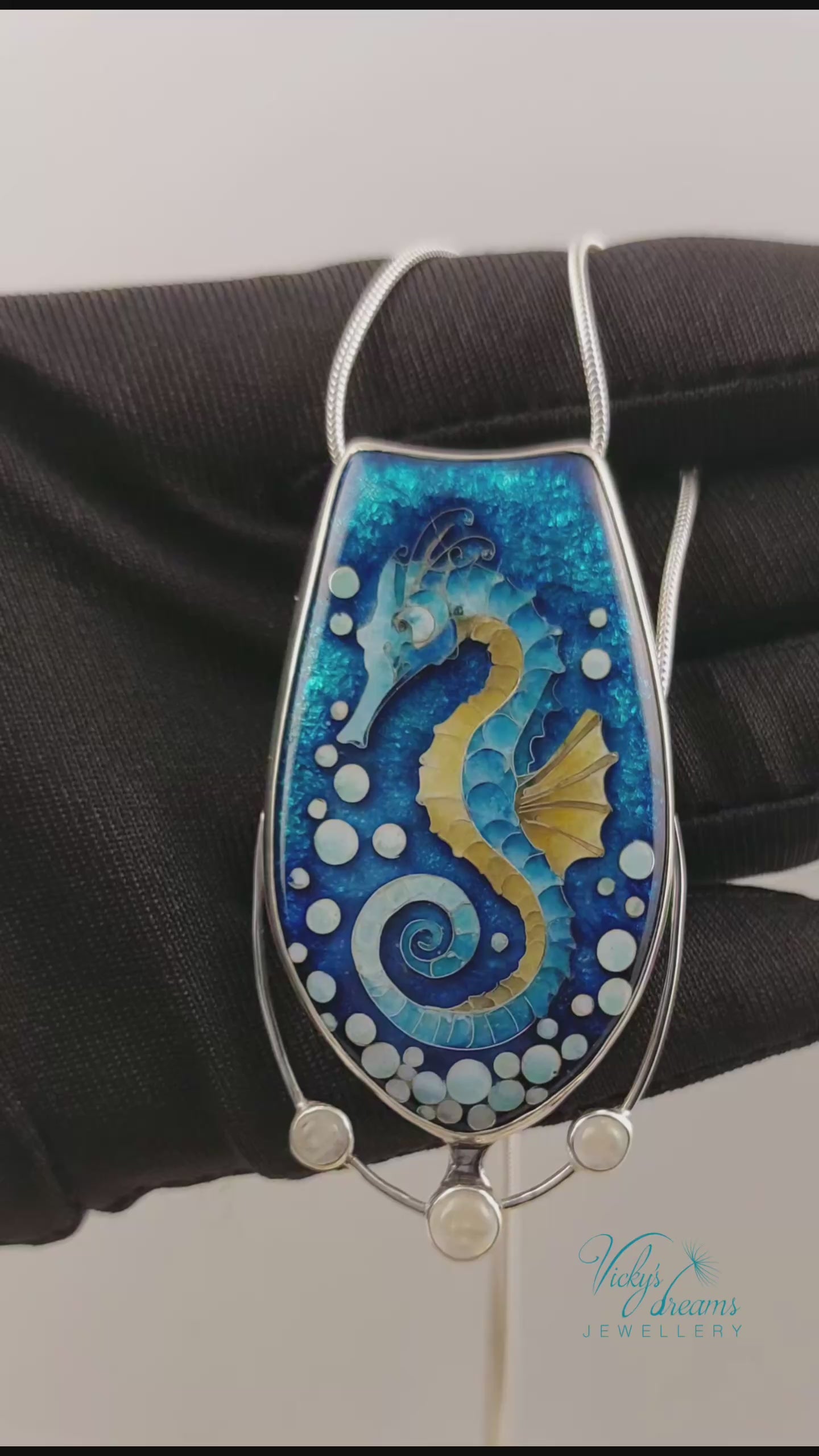 Handcrafted cloisonné seahorse pendant with vibrant enamel colors and rainbow moonstones