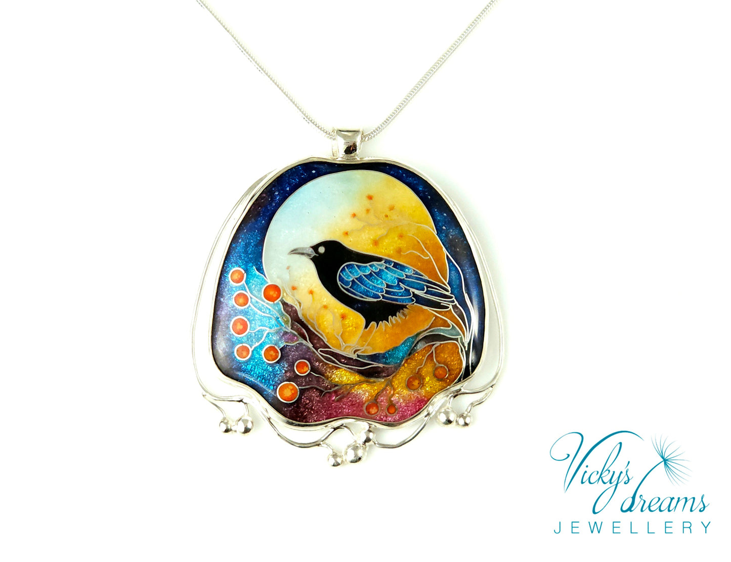 Handmade sterling silver cloisonné enamel pendant featuring a raven with red berries, vibrant blues and golden tones, nature-inspired jewellery