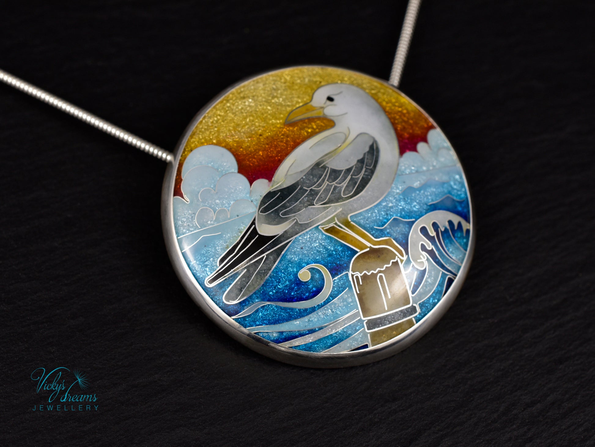 Handmade cloisonné seagull pendant necklace with sunset background