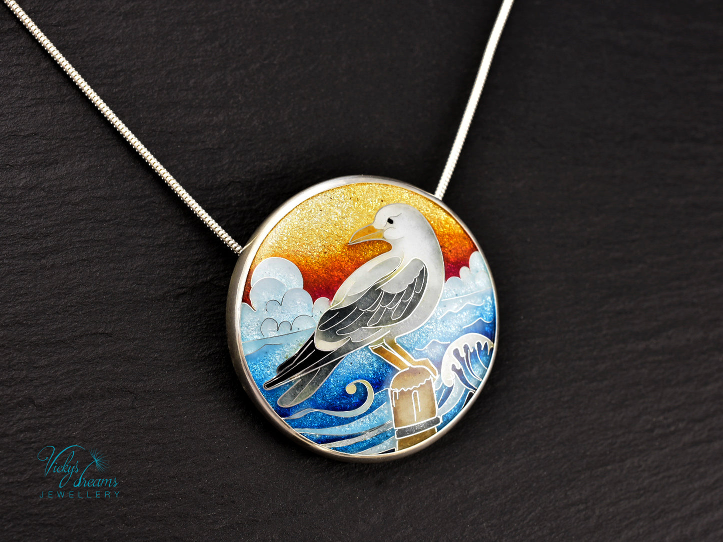 Handmade cloisonné seagull pendant necklace with sunset background
