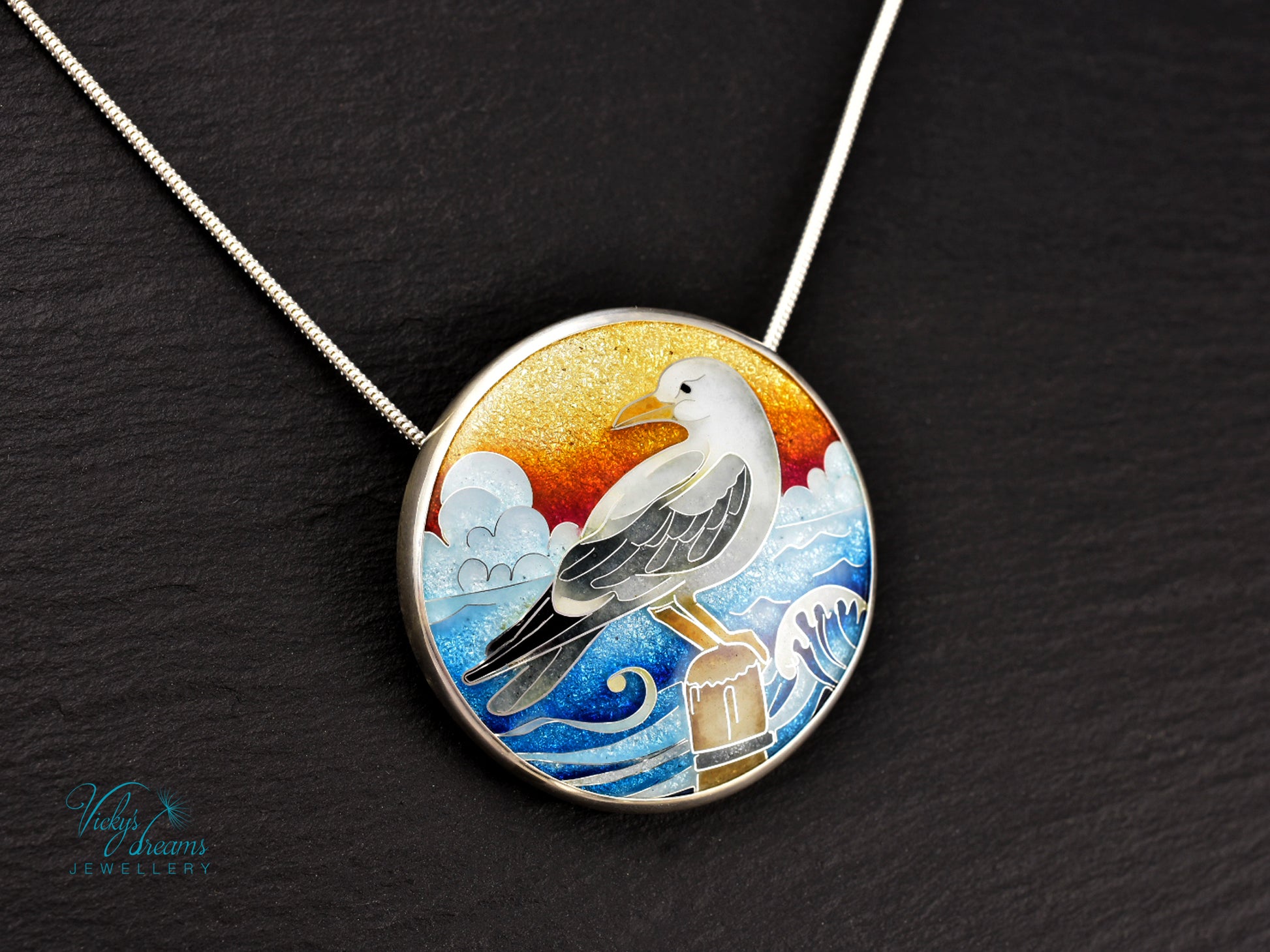Handmade cloisonné seagull pendant necklace with sunset background
