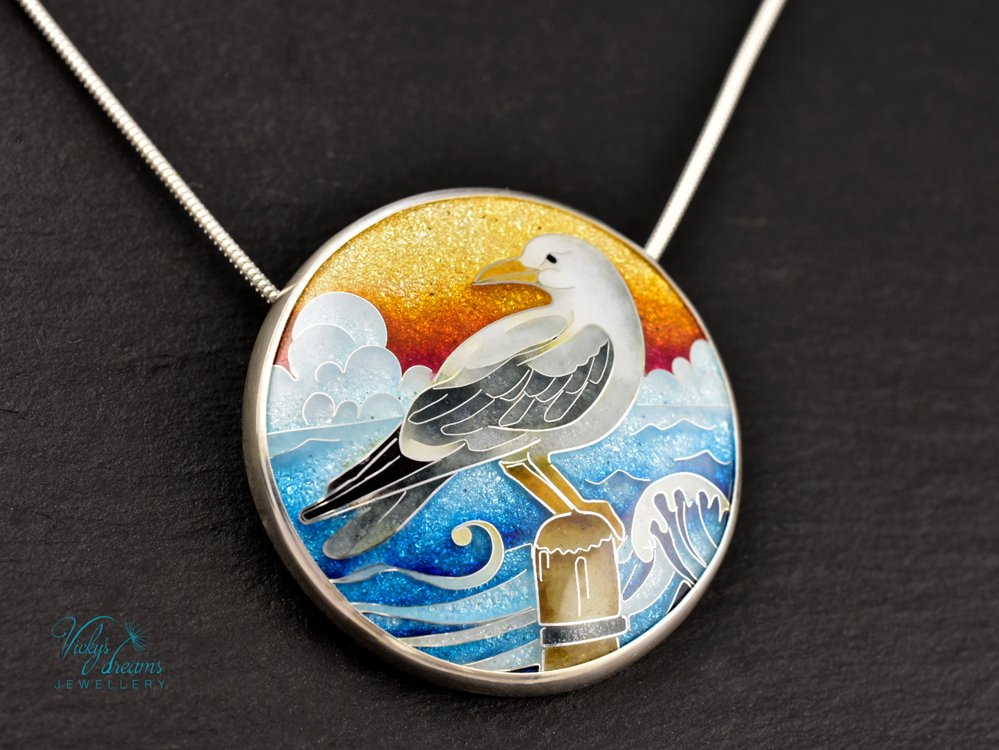 Handmade cloisonné seagull pendant necklace with sunset background