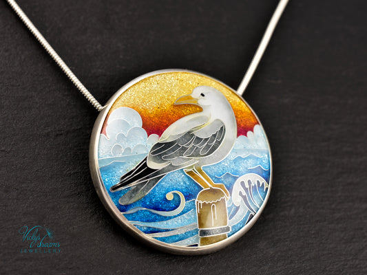 Handmade cloisonné seagull pendant necklace with sunset background