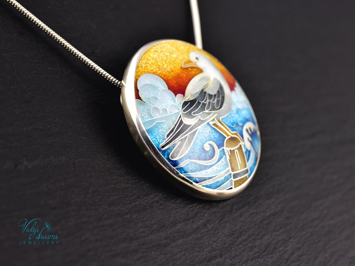 Handmade cloisonné seagull pendant necklace with sunset background