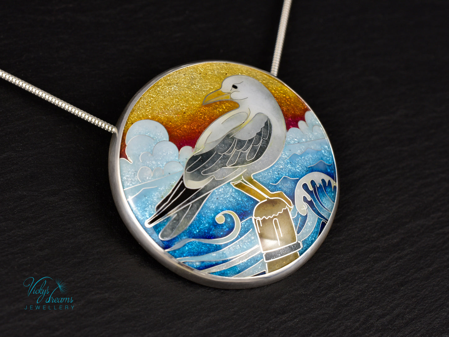 Handmade cloisonné seagull pendant necklace with sunset background