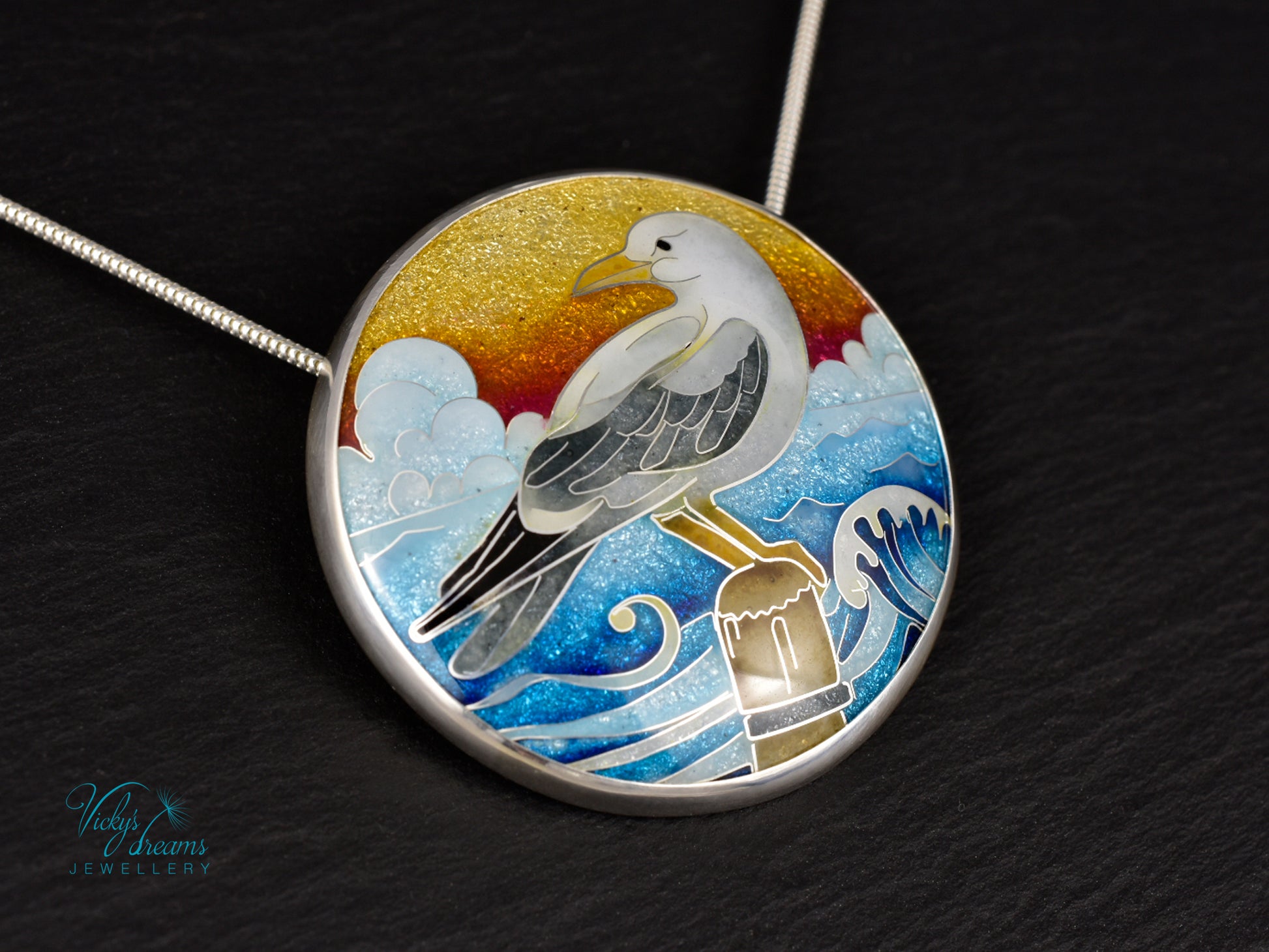 Handmade cloisonné seagull pendant necklace with sunset background