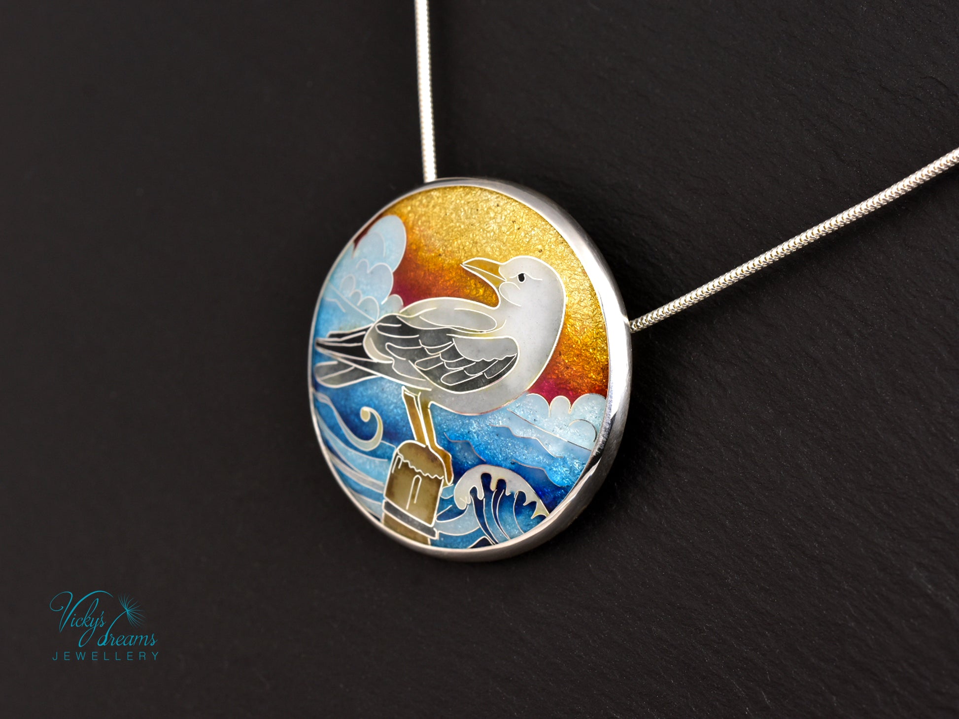 Handmade cloisonné seagull pendant necklace with sunset background