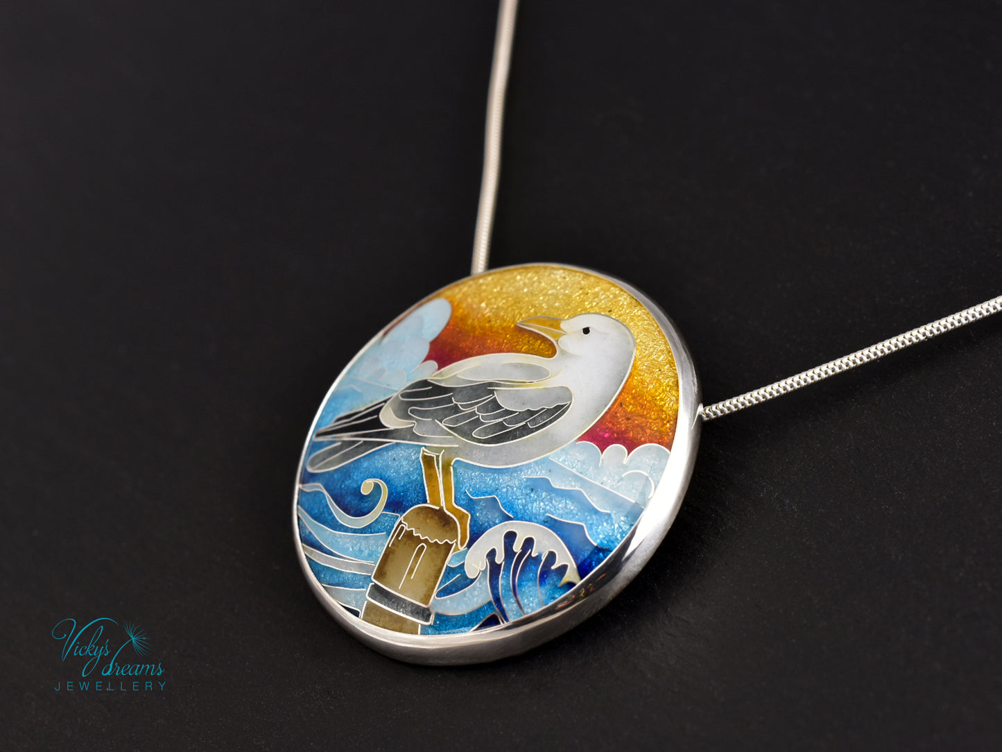 Handmade cloisonné seagull pendant necklace with sunset background