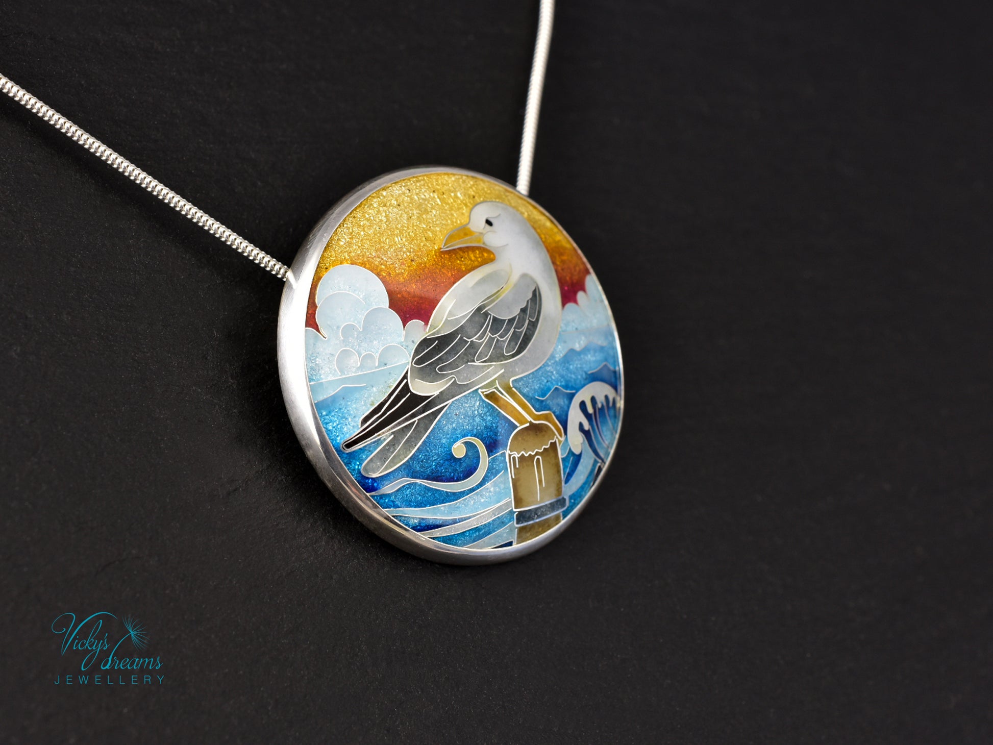 Handmade cloisonné seagull pendant necklace with sunset background