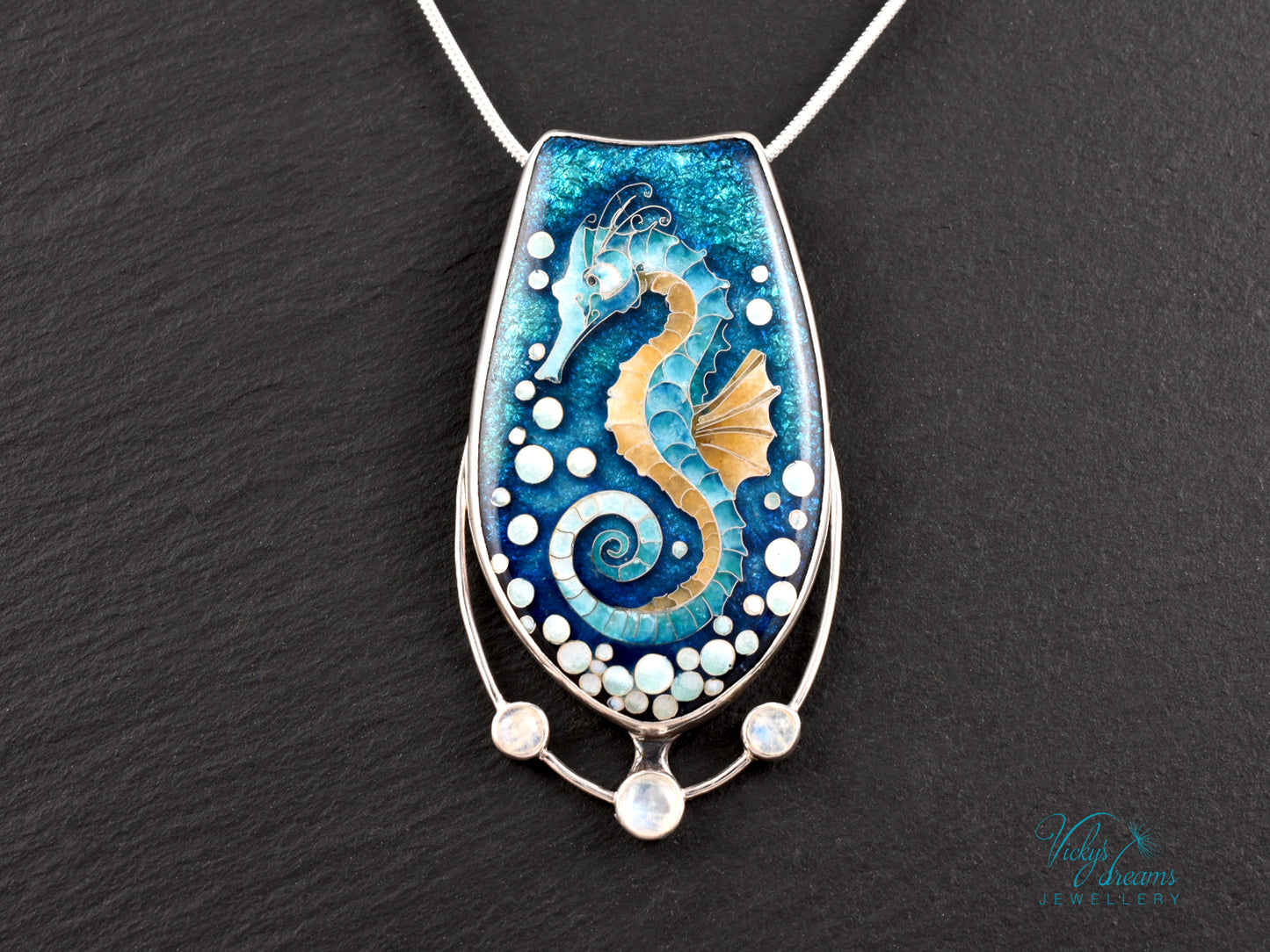Handcrafted cloisonné seahorse pendant with vibrant enamel colors and rainbow moonstones
