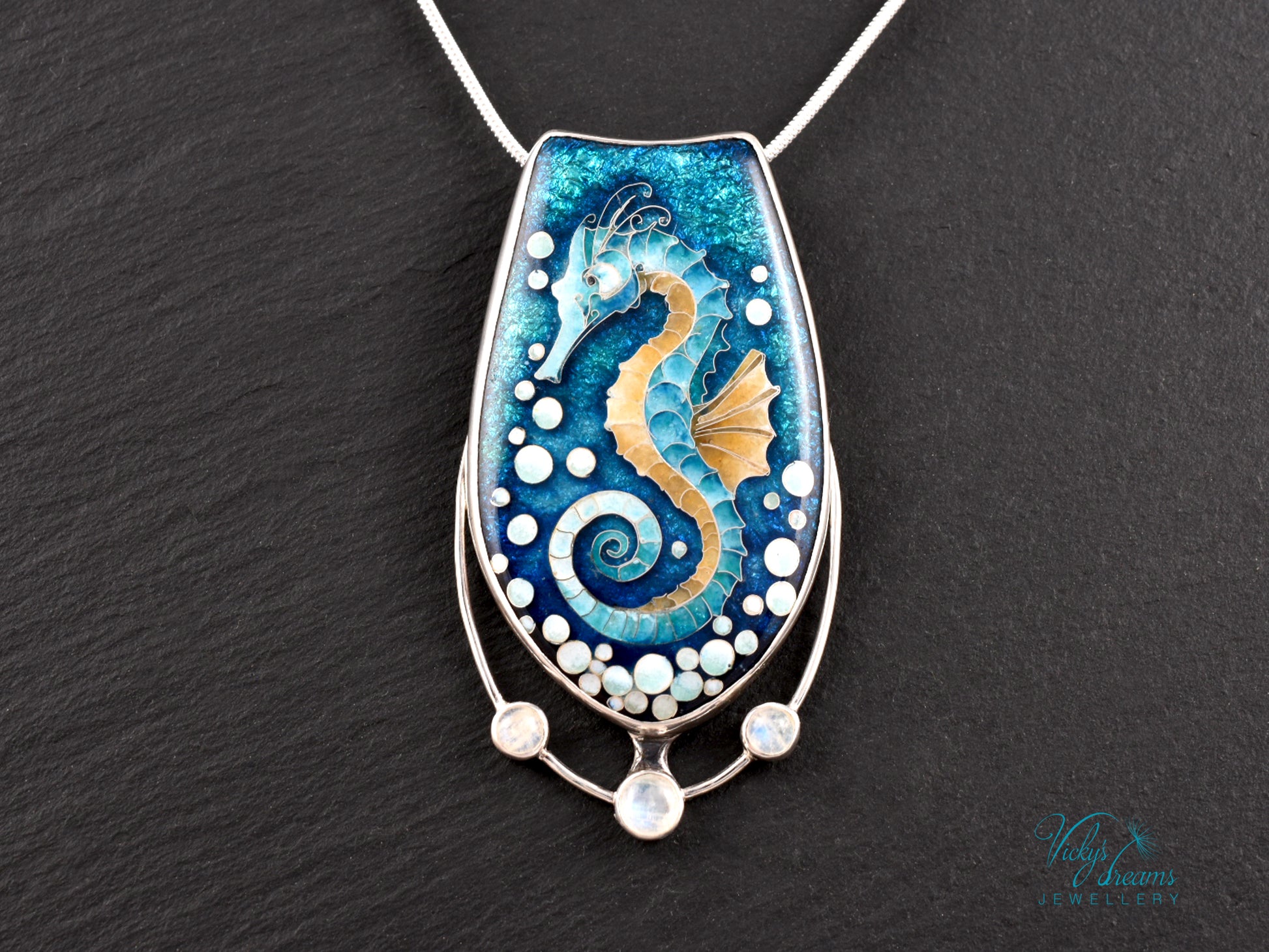 Handcrafted cloisonné seahorse pendant with vibrant enamel colors and rainbow moonstones