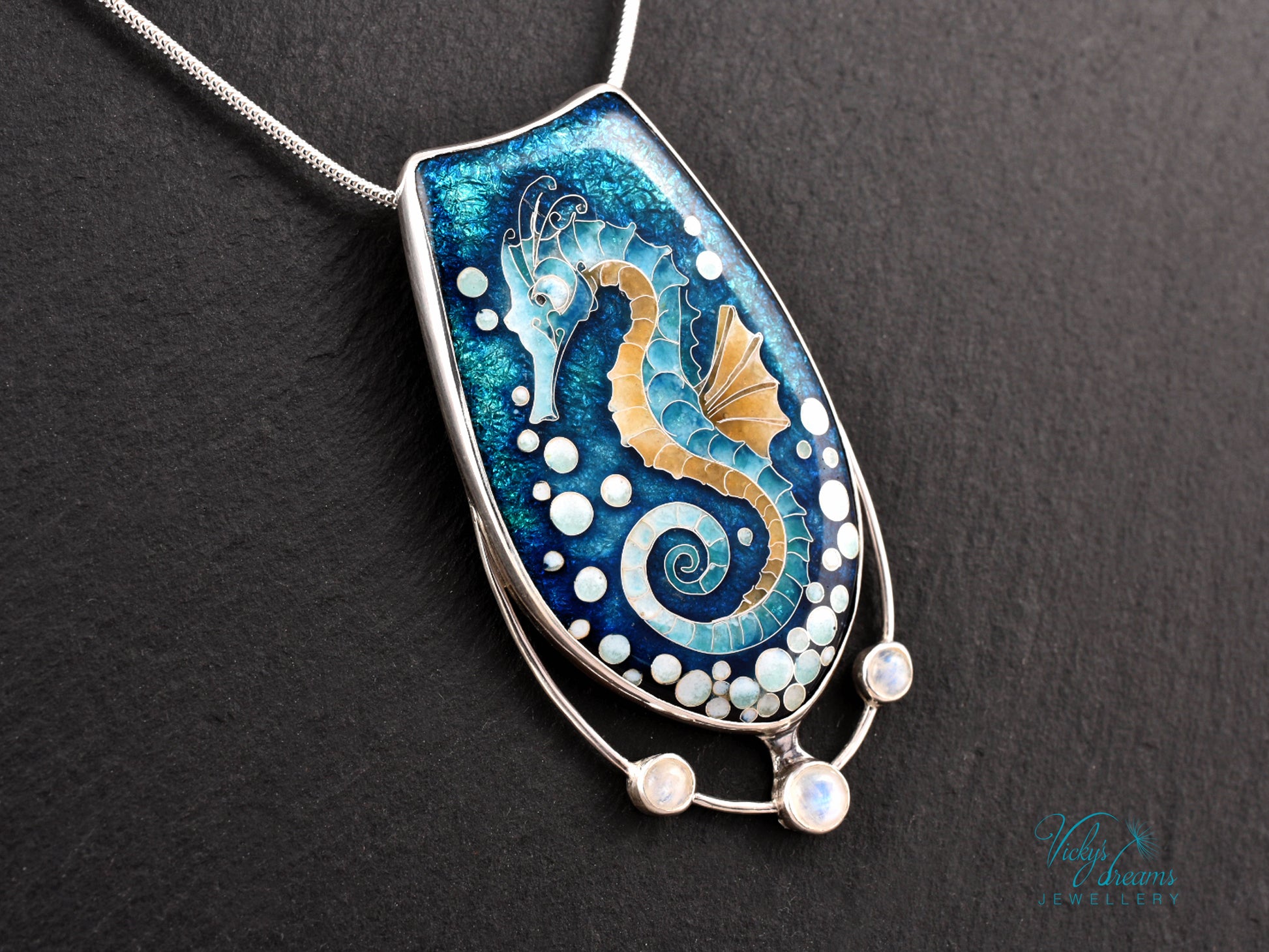 Handcrafted cloisonné seahorse pendant with vibrant enamel colors and rainbow moonstones