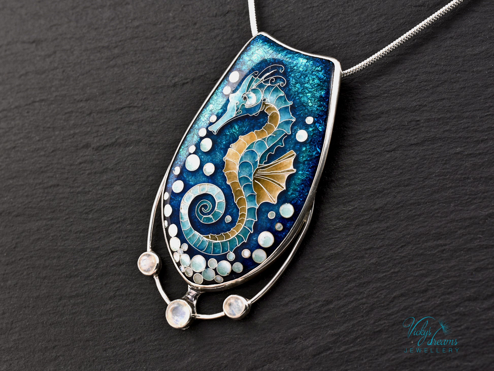 Handcrafted cloisonné seahorse pendant with vibrant enamel colors and rainbow moonstones